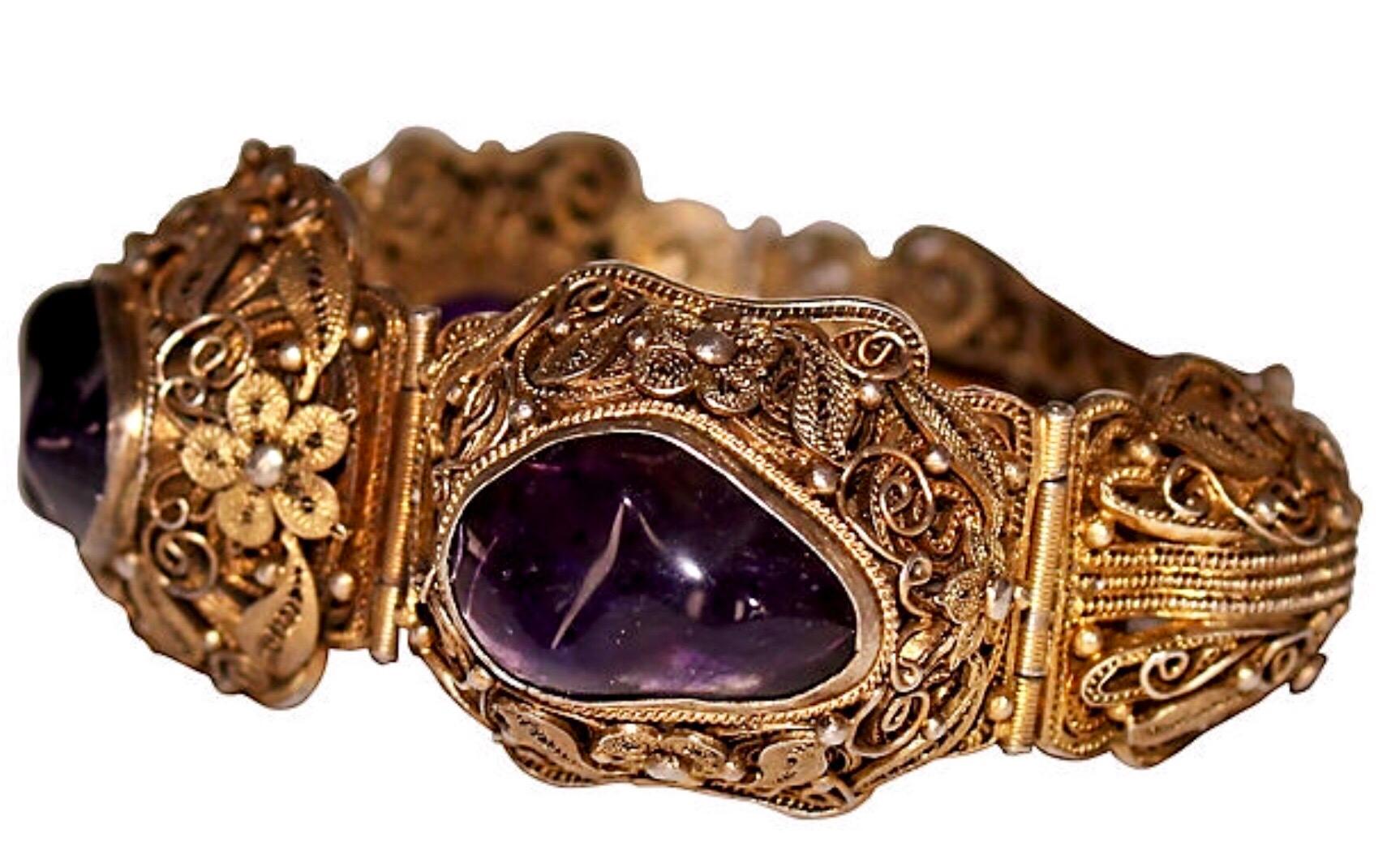 Circa 1940s to 1950s ornate gold-plated sterling silver bracelet with a lot of beautiful filigree detail.  It is bezel set with large amethyst nugget stones.  The bracelet measures 7.25