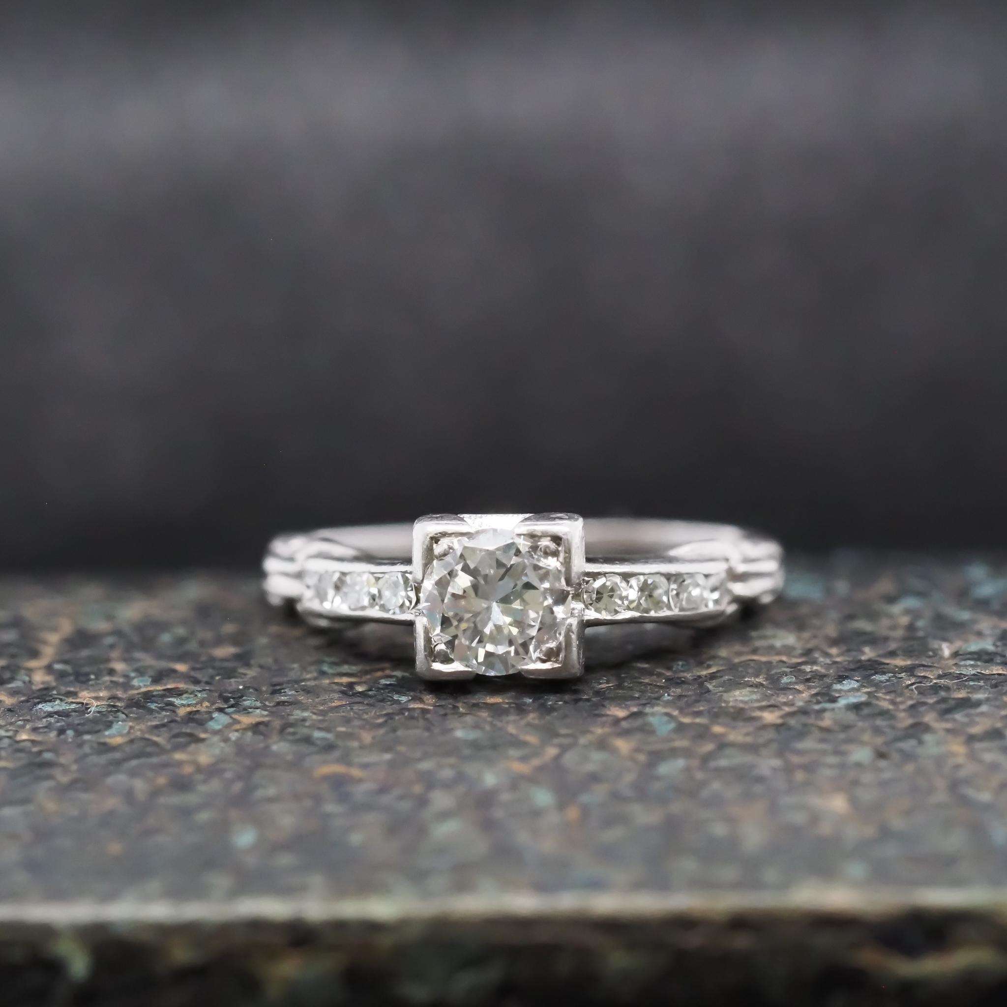 Year: 1940s
Item Details:
Ring Size: 5.5 (Sizable)
Metal Type: Platinum [Hallmarked, and Tested]
Weight: 3.0 grams
Center Diamond Details: .55ct, Old European Transitional Cut, F Color, VS Clarity
Side Stone Details: .15ct total weight, Old European