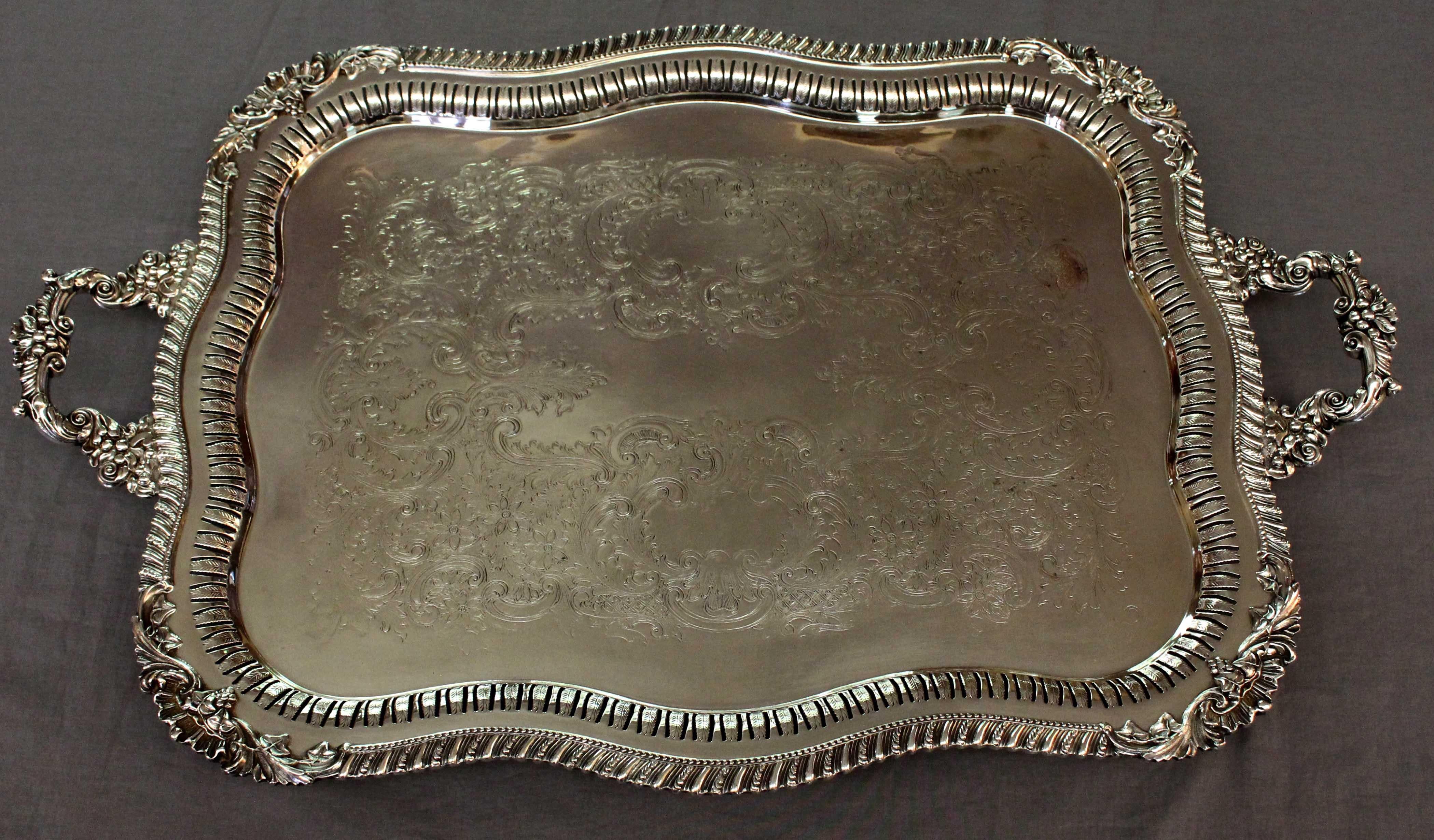Circa 1940s silver on copper tea tray by the Crown Silver Co, Brookline, MA. Made after 1933. Cast borders & an inner reticulated border create a classic design. The borders & handles with shells & grapes. Shell & scroll feet . Some light bleeding &