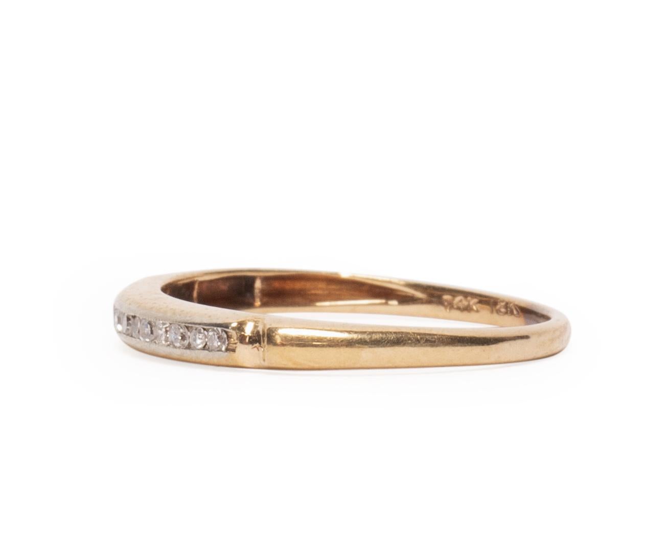 Here we have a beautiful 1940's Art Deco piece that contains 14 gorgeous diamonds set in a 14K white gold channel along the top of the band, leaving the rest of the ring yellow gold giving the two tone effect. With a dainty design on both sides of