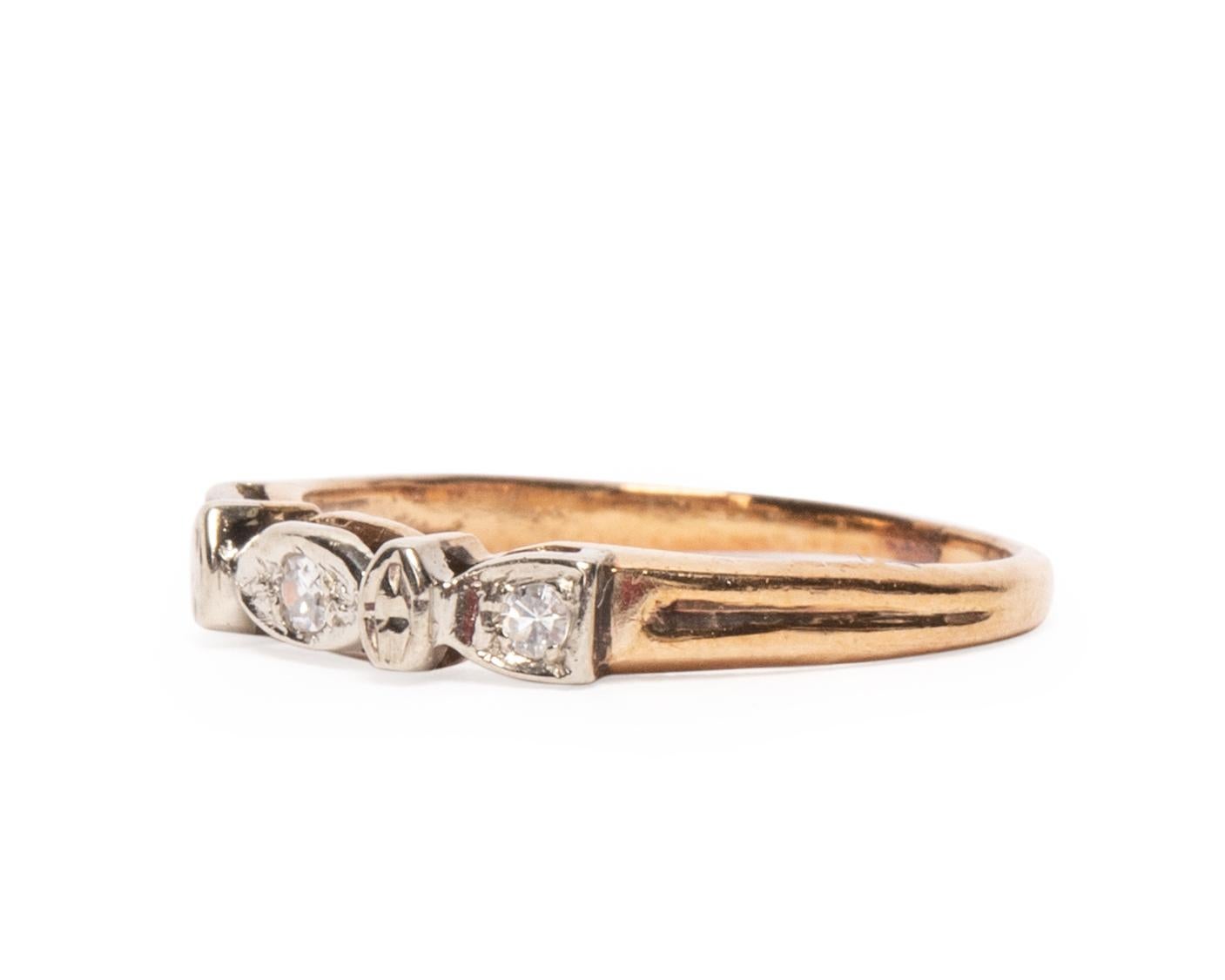 Here we have a beautiful 1930's Art Deco piece in a unique geometric design,  the diamonds are set in the 14K white gold pattern along the top of the band, leaving the rest of the ring yellow gold giving the two tone effect. With a dainty design on