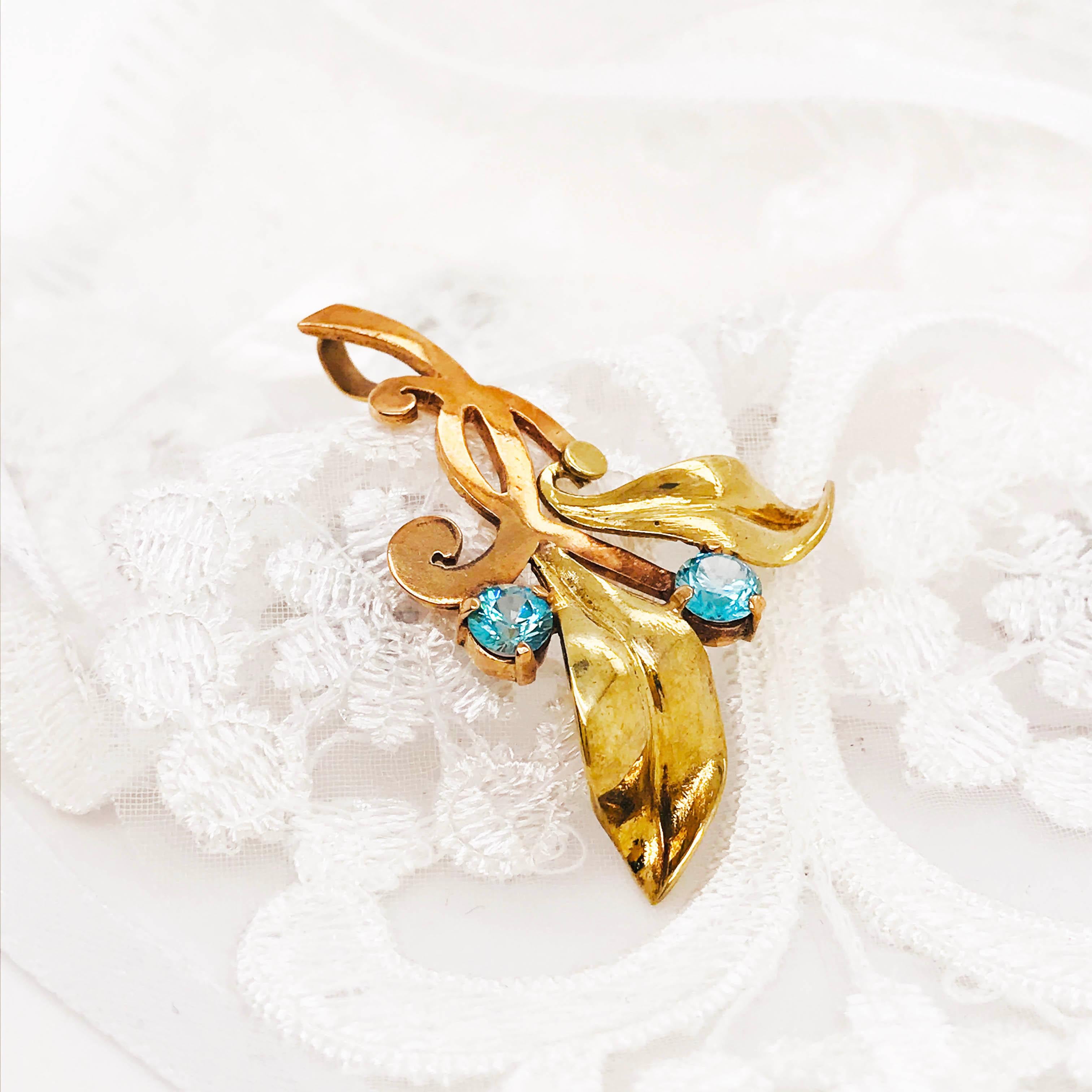 CIRCA 1950 1.00 Carat Swiss Blue Topaz Leaf Pendant in 18K Yellow and Rose Gold! How unique is this piece? This blue topaz Pendant has an ornate leaf design with two genuine Swiss blue topaz gemstones set in a balanced design. This is an estate,