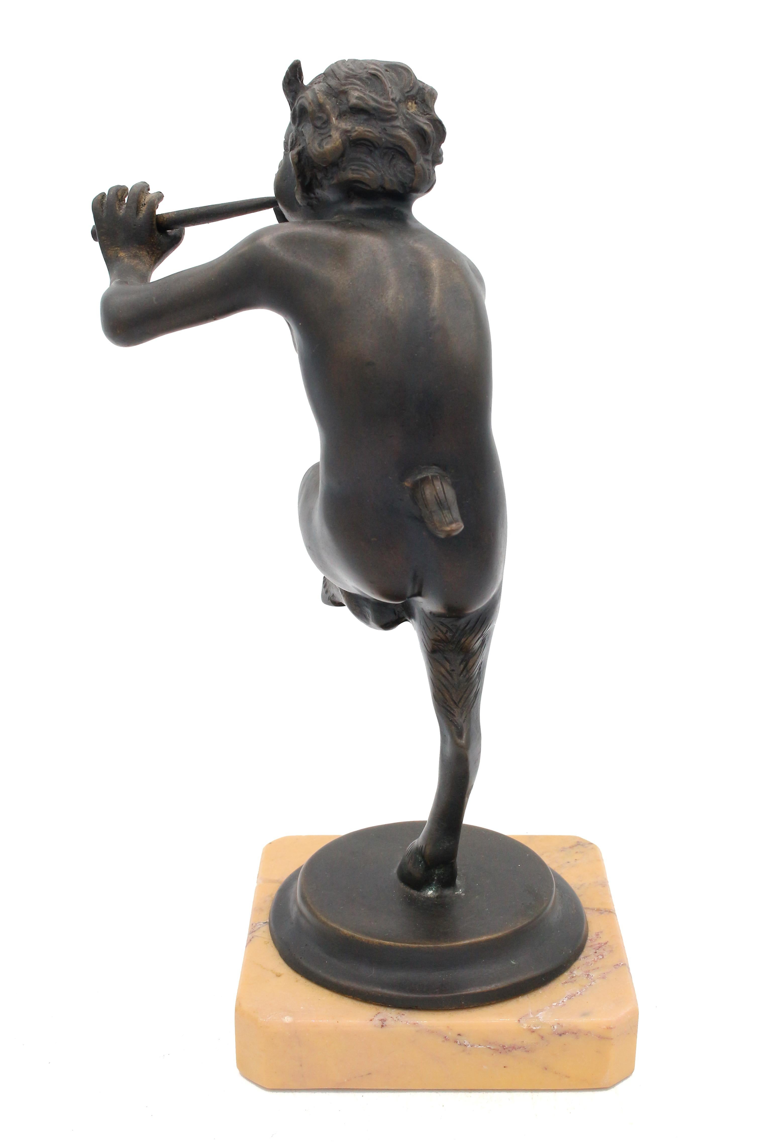 Circa 1930-50 Italian bronze figure of Pan on marble base. Pan, the Greek god of the wild, of shepherds & of rustic music. He is playing the panpipes. Siena marble base.
9.25