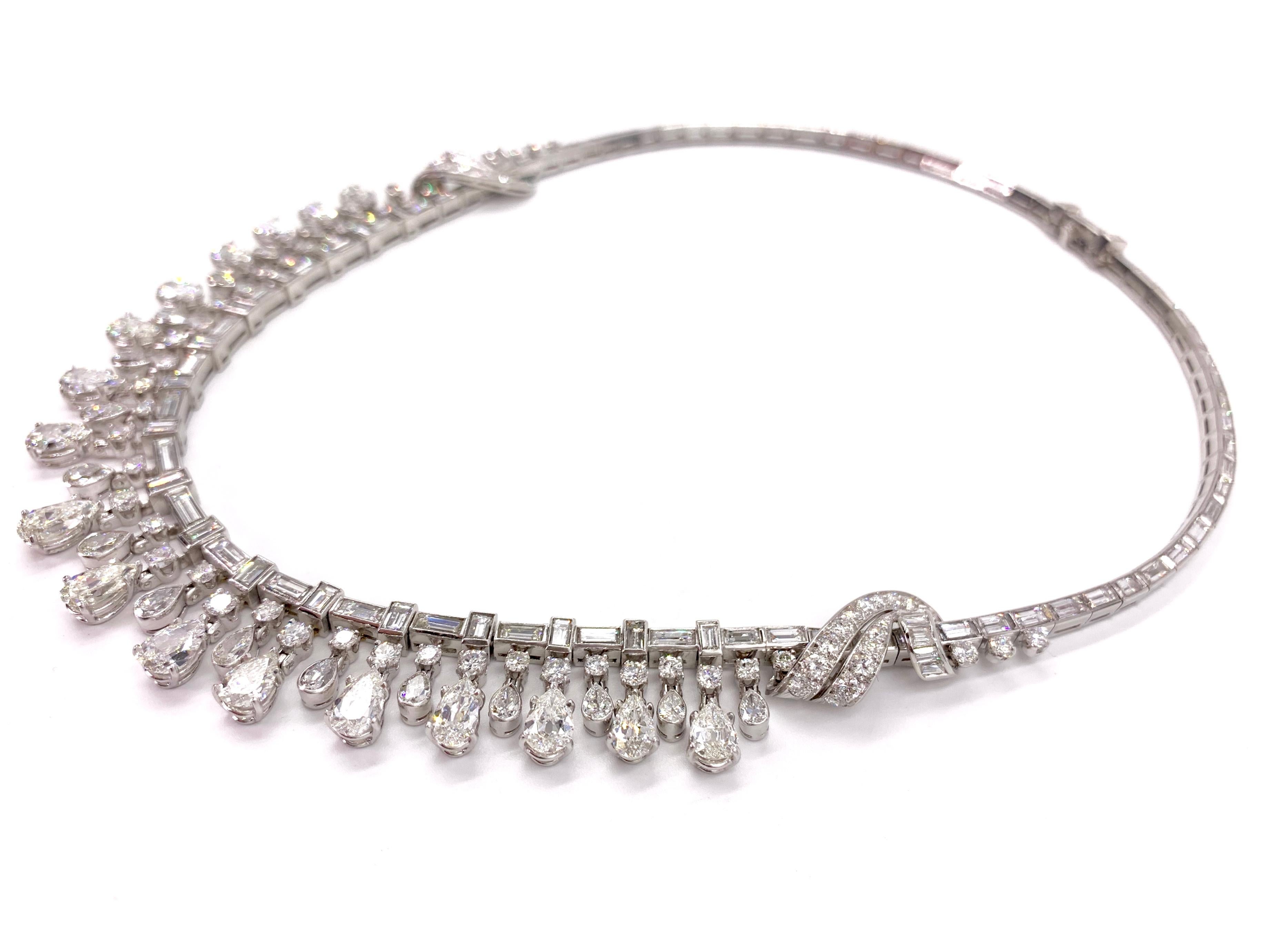 A showstopper platinum necklace featuring approximately 43 carats of brilliant diamonds with a timeless and elegant design. Graduated round and pear shaped diamonds dangle beautifully from the center of the piece. Each link is bezel set with a