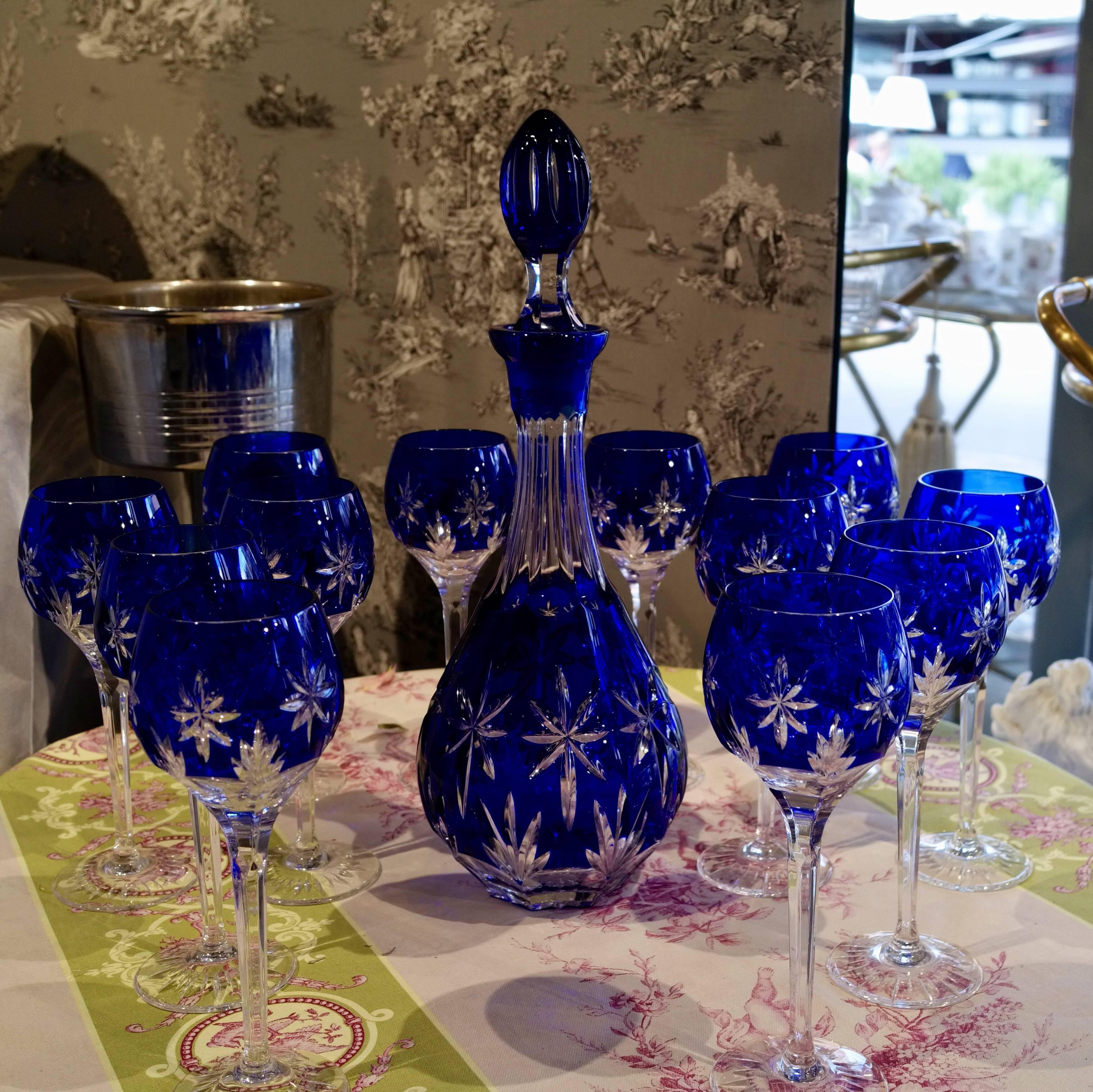 Blue crystal service, one carafe and 12 stemmed glasses, circa 1950.
Bohemian style !
Nice deep engravings. In very good condition.
Dimensions : 
Glass : Height 21.5 cm / Diameter 6.5 cm
Carafe : Height 40.5 cm / Diameter 13.5.