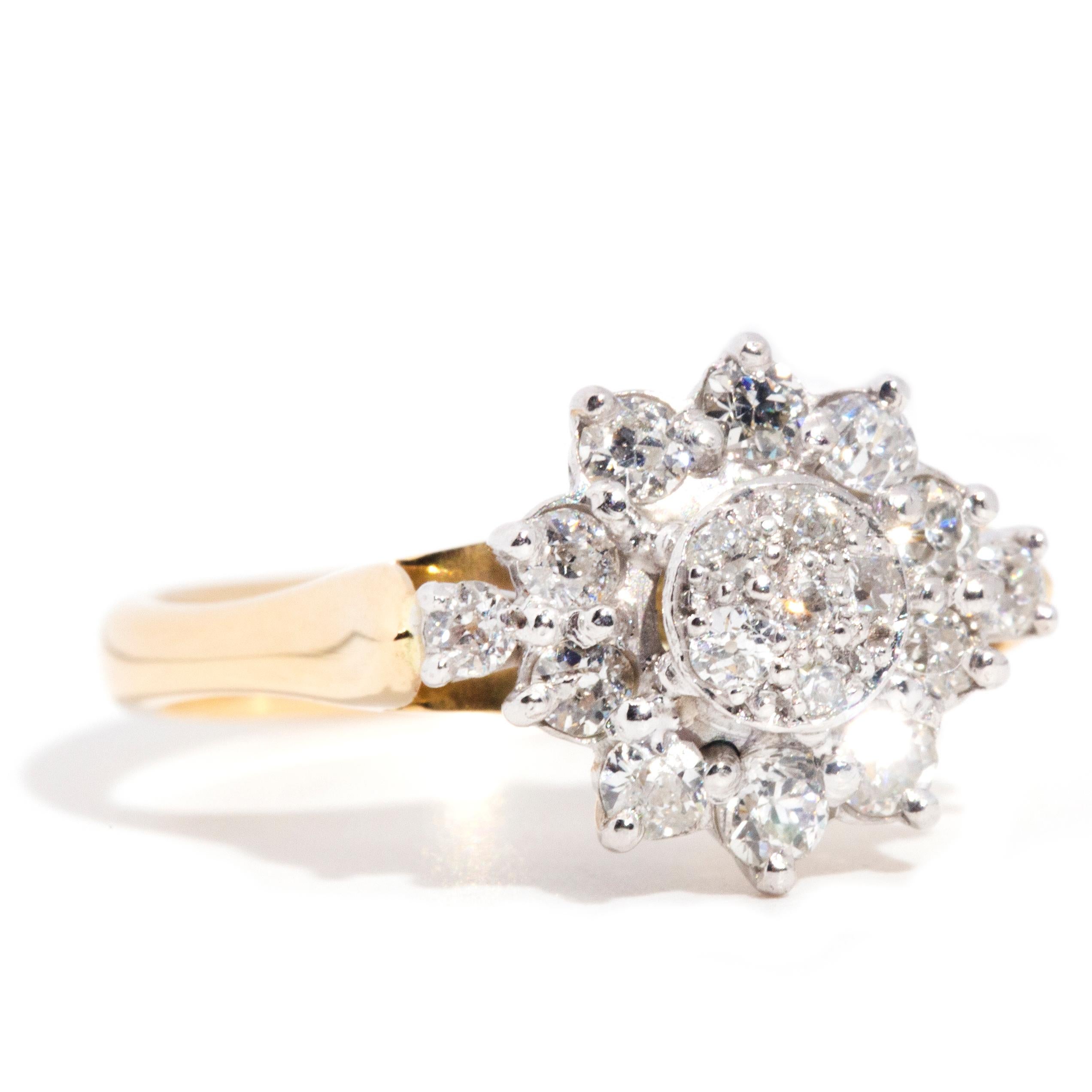 Forged in 9 carat yellow and white gold, this enchanting vintage ring features a captivating gallery with a cluster of five shimmering Old Cut diamonds at the centre and a surrounding starburst cluster radiating from outside the central cluster.