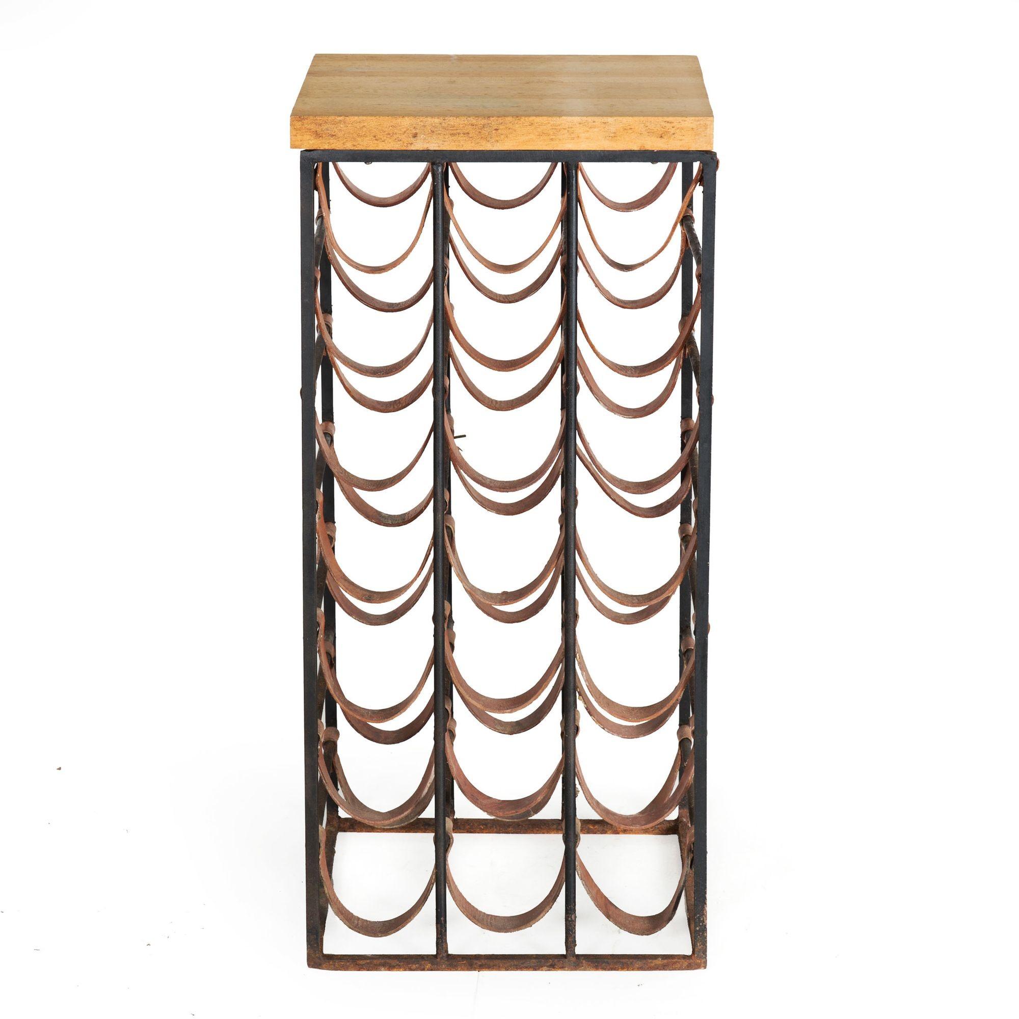 A lovely Arthur Umanoff accent table with a maple butcher's block top over a wrought-iron base, it is designed to hold 21 wine bottles in the loops of rawhide leather that hang from the iron frame. The vintage table has been left exactly as it was