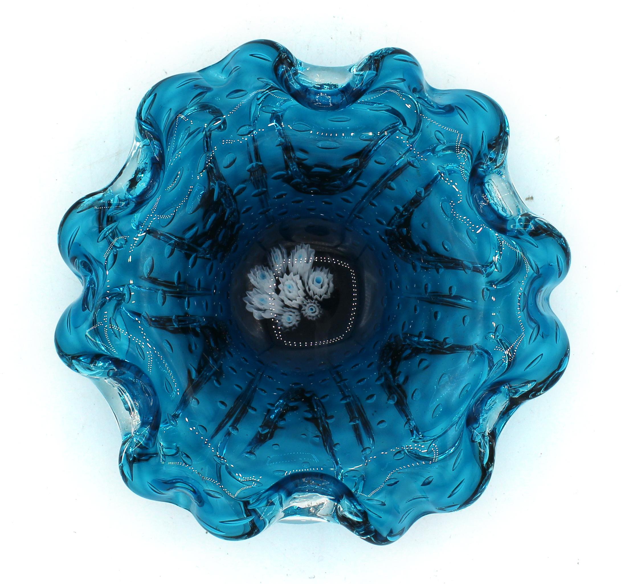 Circa 1950s Murano glass bowl. Blue & clear bullicante (controlled bubbles) piece suitable for candy or a fine cigar. The drifting canes in the bottom add to the visual impact. Fine condition.
7.25