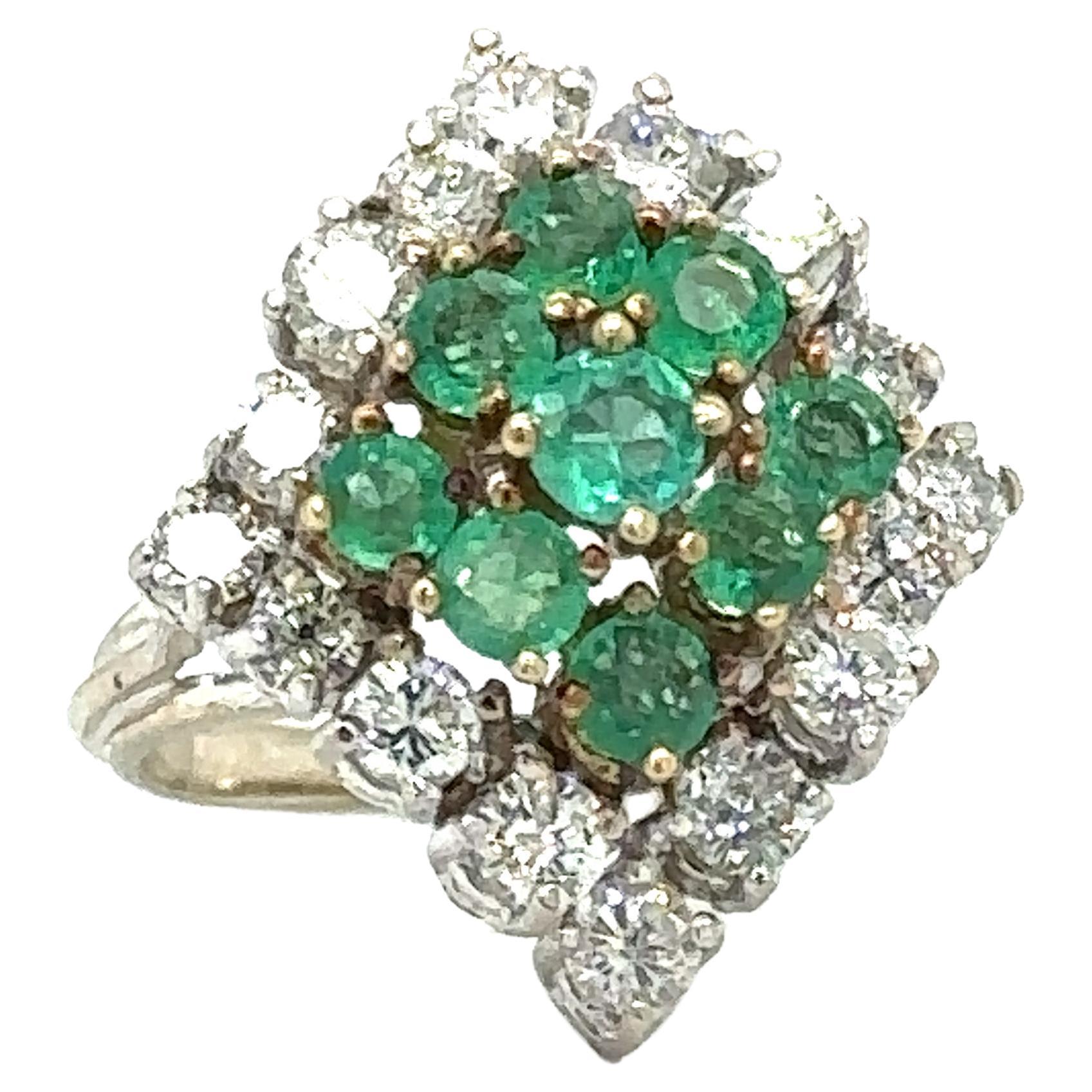 Item Details: This cocktail ring studded with gemstones has over a carat each of diamonds and Colombian emeralds.

Circa: 1950s
Metal Type: 14 Karat White and Yellow Gold
Weight: 7.7 grams
Size: US 5, resizable

Diamond Details:
Carat: 1.0 carat