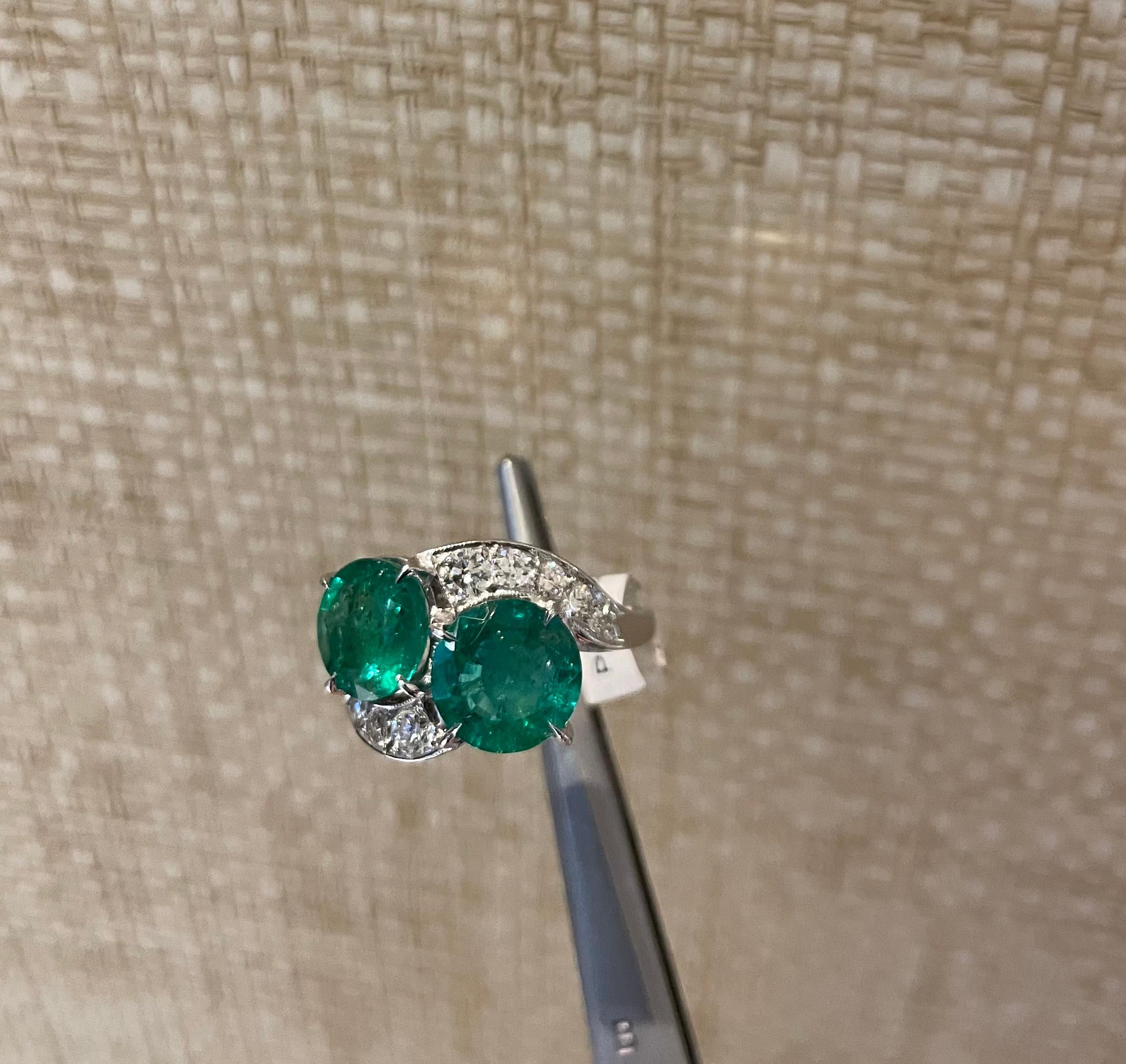 Beautiful emerald and diamond ring with a unique vintage design. Approximately 4.5 carats of round emeralds and .75 carats of round brilliant diamonds set in platinum

Size 6.5