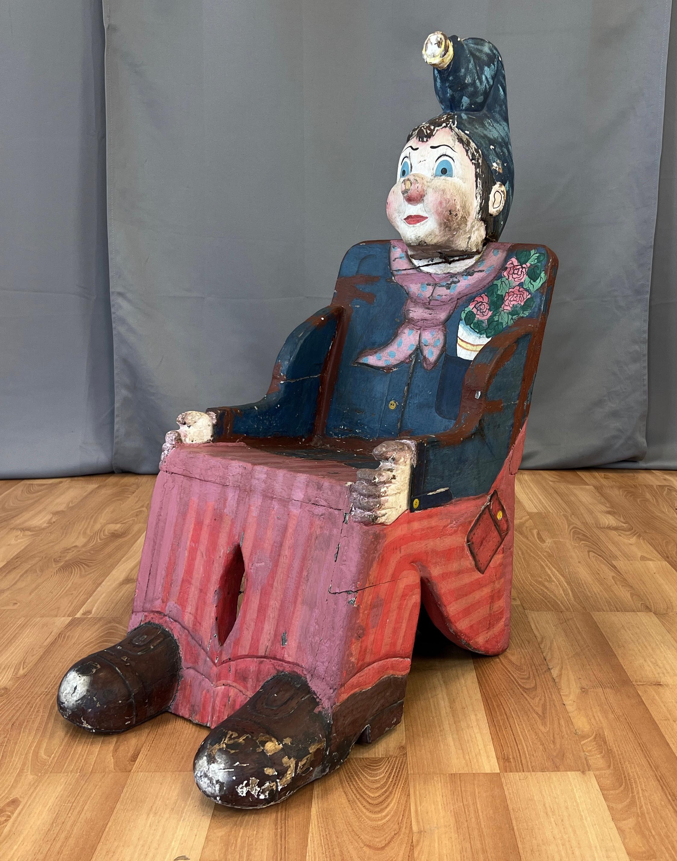A wonderful whimsical circa 1950s French Childs Carnival and/or Circus prop chair.
Carved parts, feet, hands and head with big blue eyes and top it off a fun blue hat falling forward.
The wooden chair's paint has faded over the years but still has