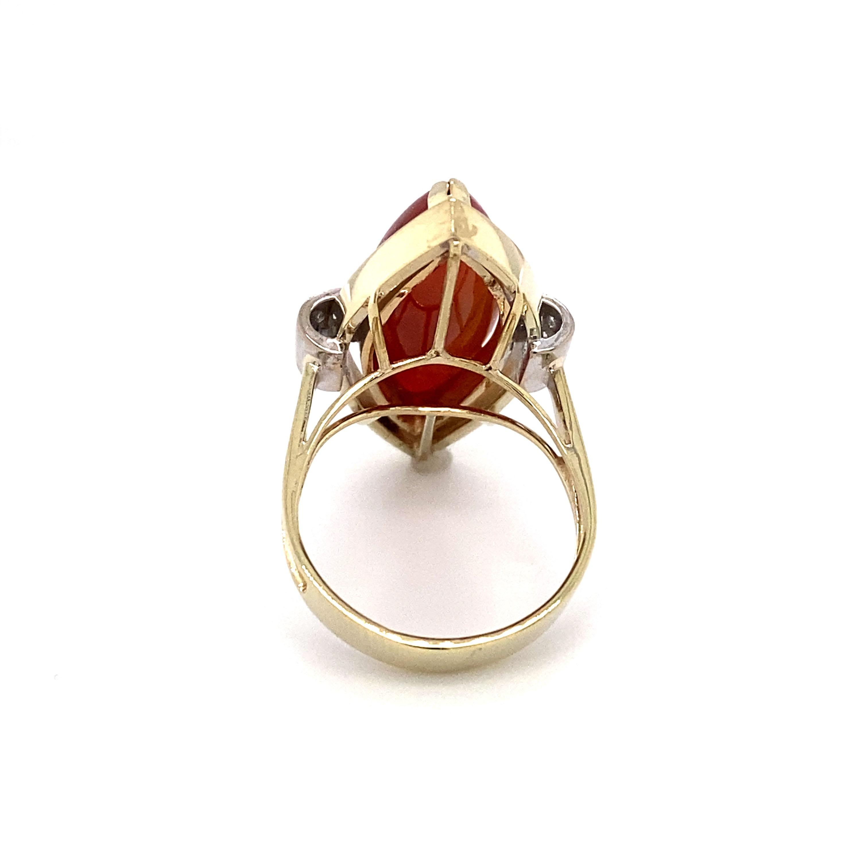 Circa: 1950s
Metal Type: 14K Gold
Size: US 6.5
Weight: 9.4g

Carnelian Details:

Cut: Marquise
Measurements: 20mm L
Color: Rosy brown with a hint of orange