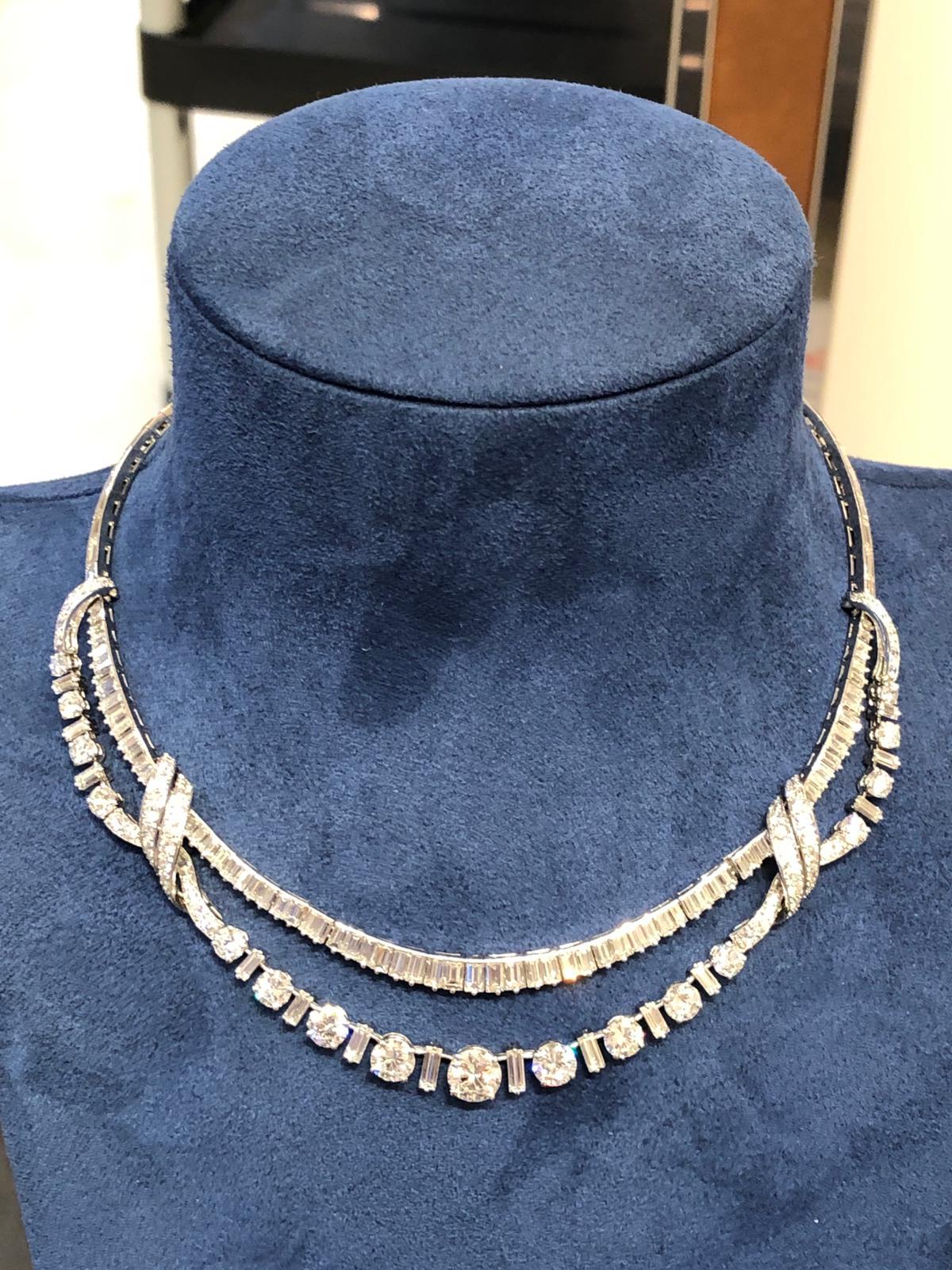 A remarkable necklace that dates back to the 1950s, of swag design, filled with baguette cut diamonds weighing approximately 28 carats and round cut diamonds weighing approximately 1.45 carats, finely mounted in platinum. 
Inner circumference
