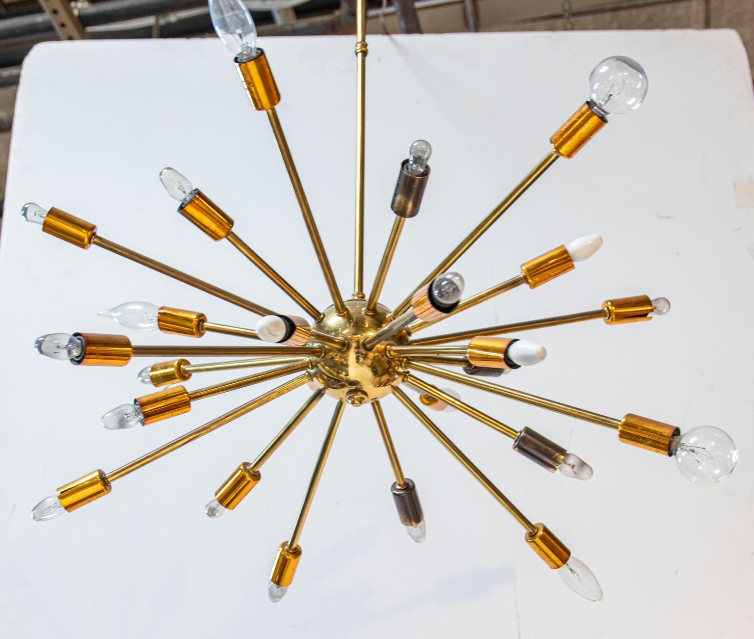 Circa 1950s Mid-Century Modern style rare Sputnik shaped pendant light fixture. The piece with various arms radiating from a central spherical core was directly inspired by similar construction of the Russian 