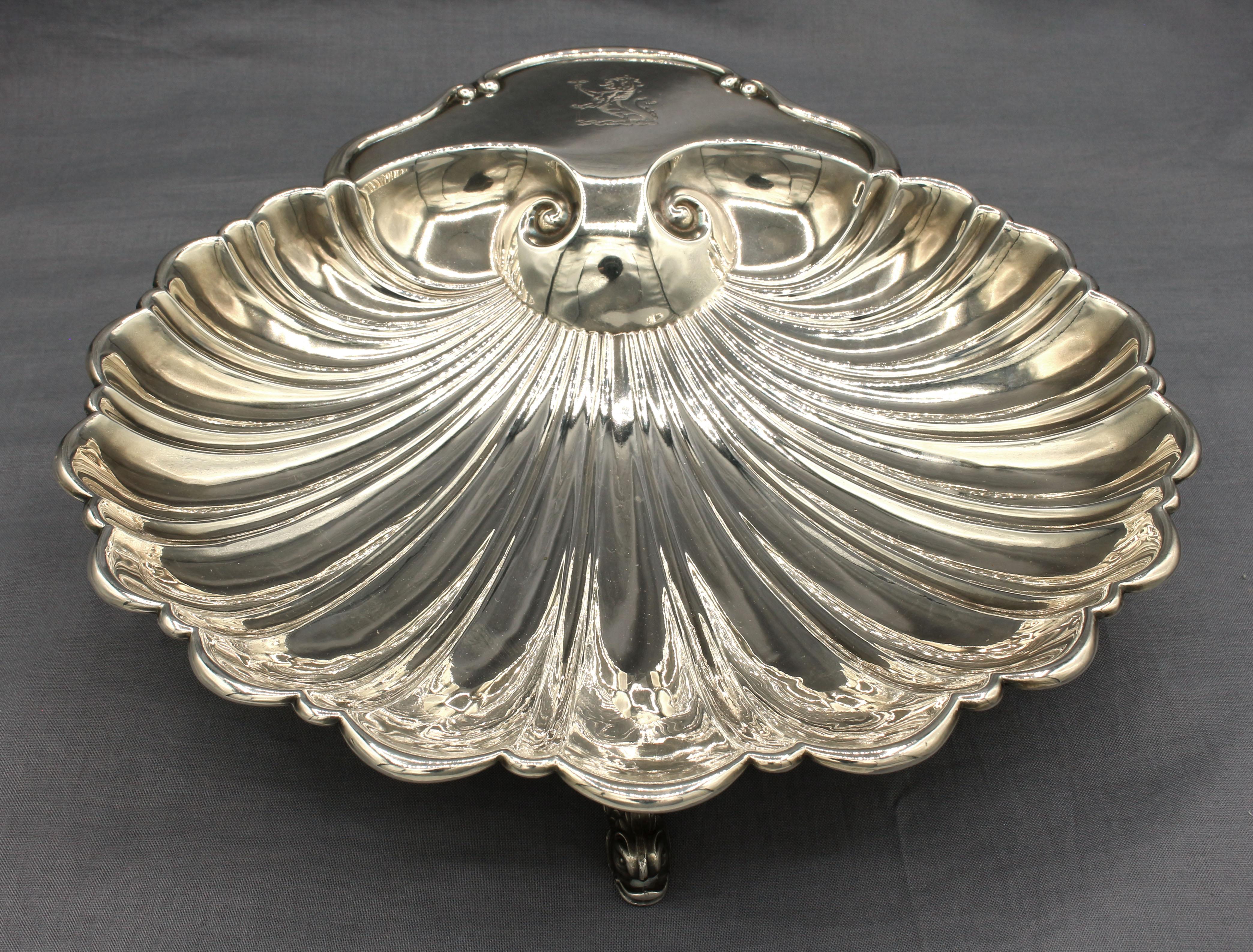 Scallop shaped serving bowl, silver plate, circa 1950s. Elegant dolphin feet, pseudo English crest decoration. Crescent silverware (now part of Kirk). Measures 10 1/8