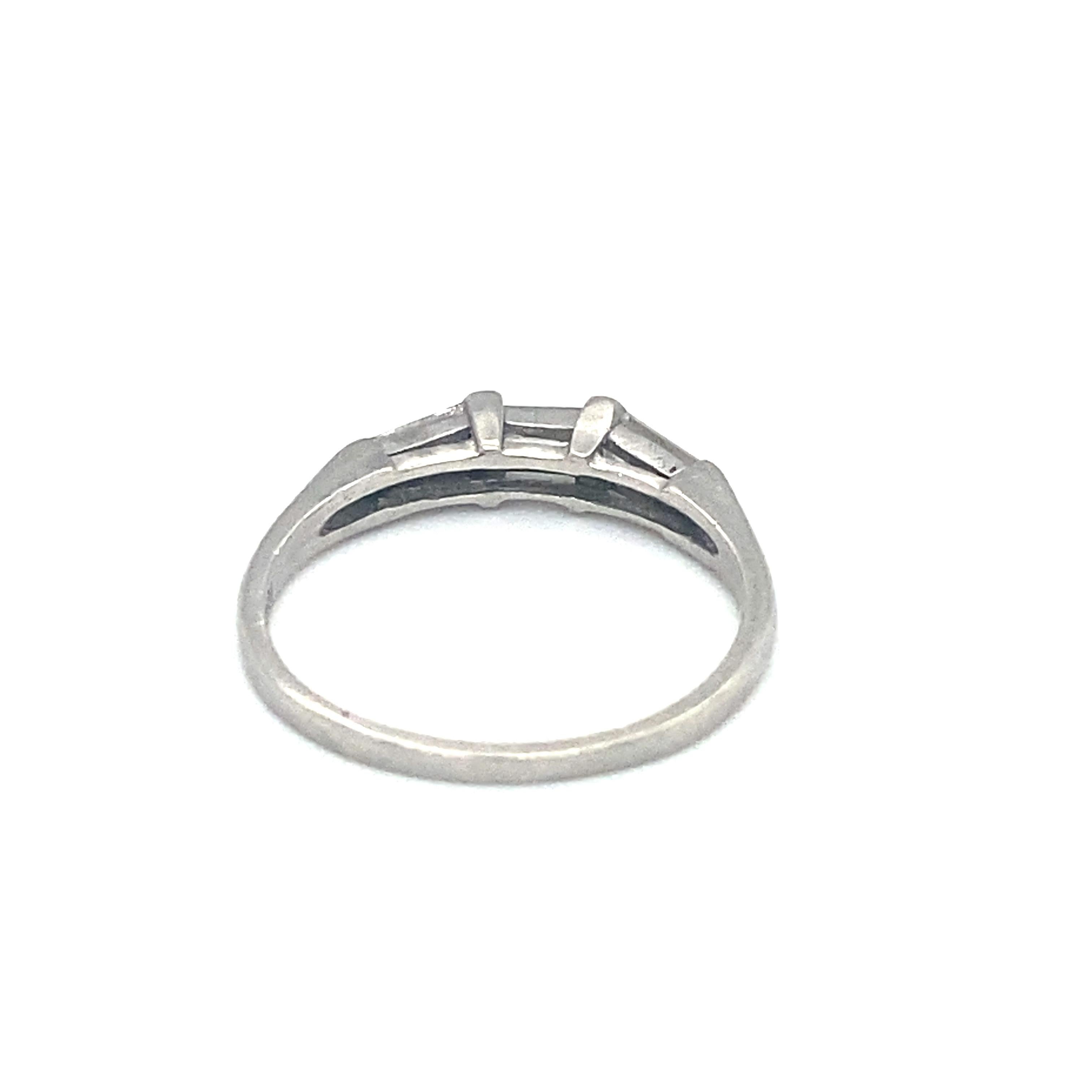 Item Details: This vintage ring has three baguette diamonds and makes a great companion to your engagement ring!

Circa: 1950s
Metal Type: Platinum
Weight: 2.6g
Size: US 6.25