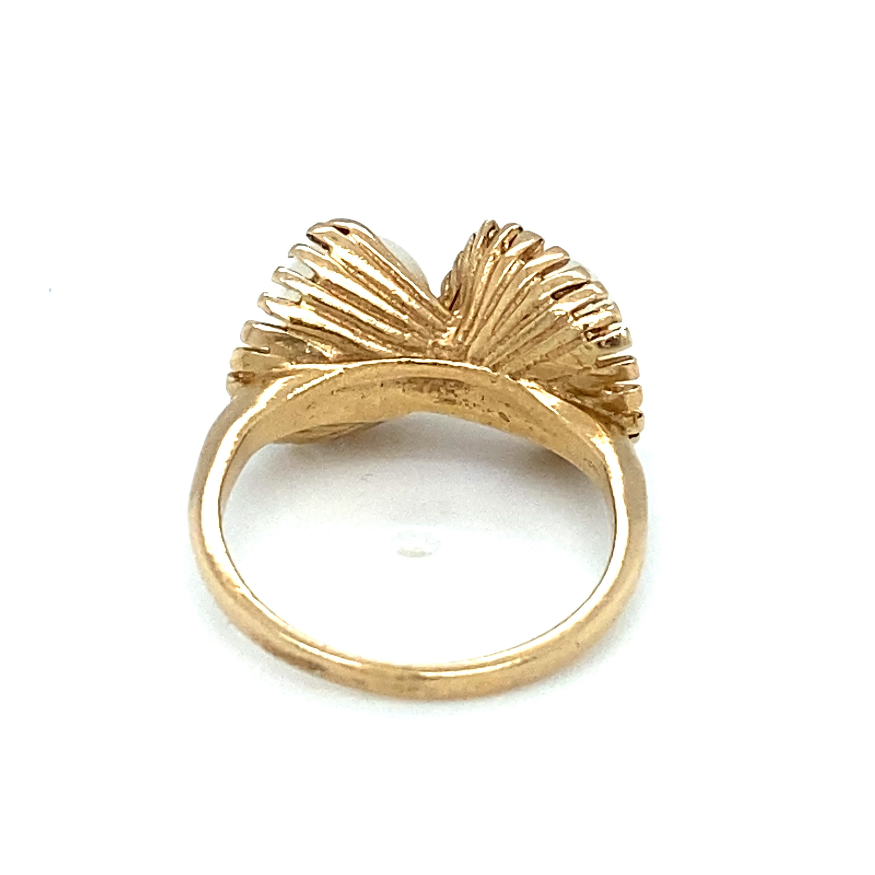 Item Details: This unique vintage ring has two twinned freshwater pearls with a crossed fan design.

Circa: 1950s
Metal Type: 14 Karat Yellow Gold
Weight: 2.9 Grams
Size: US 3, resizable
