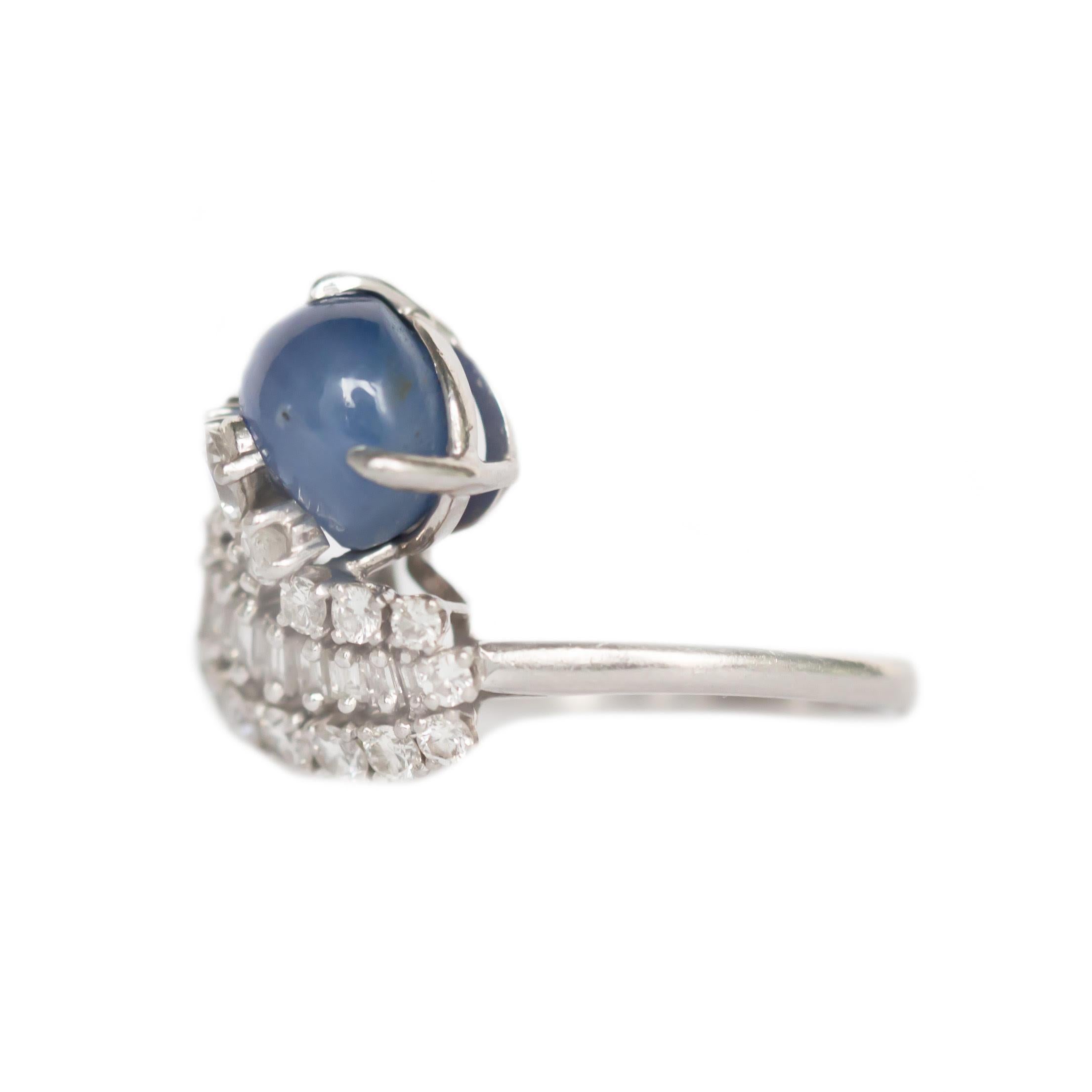 This is an exquisite example of a retro color stone ring, featuring dazzling diamonds that lead to a deep blue star sapphire!  This would make an excellent addition to any vintage lover's collection. 

This is a true antique piece, and we are