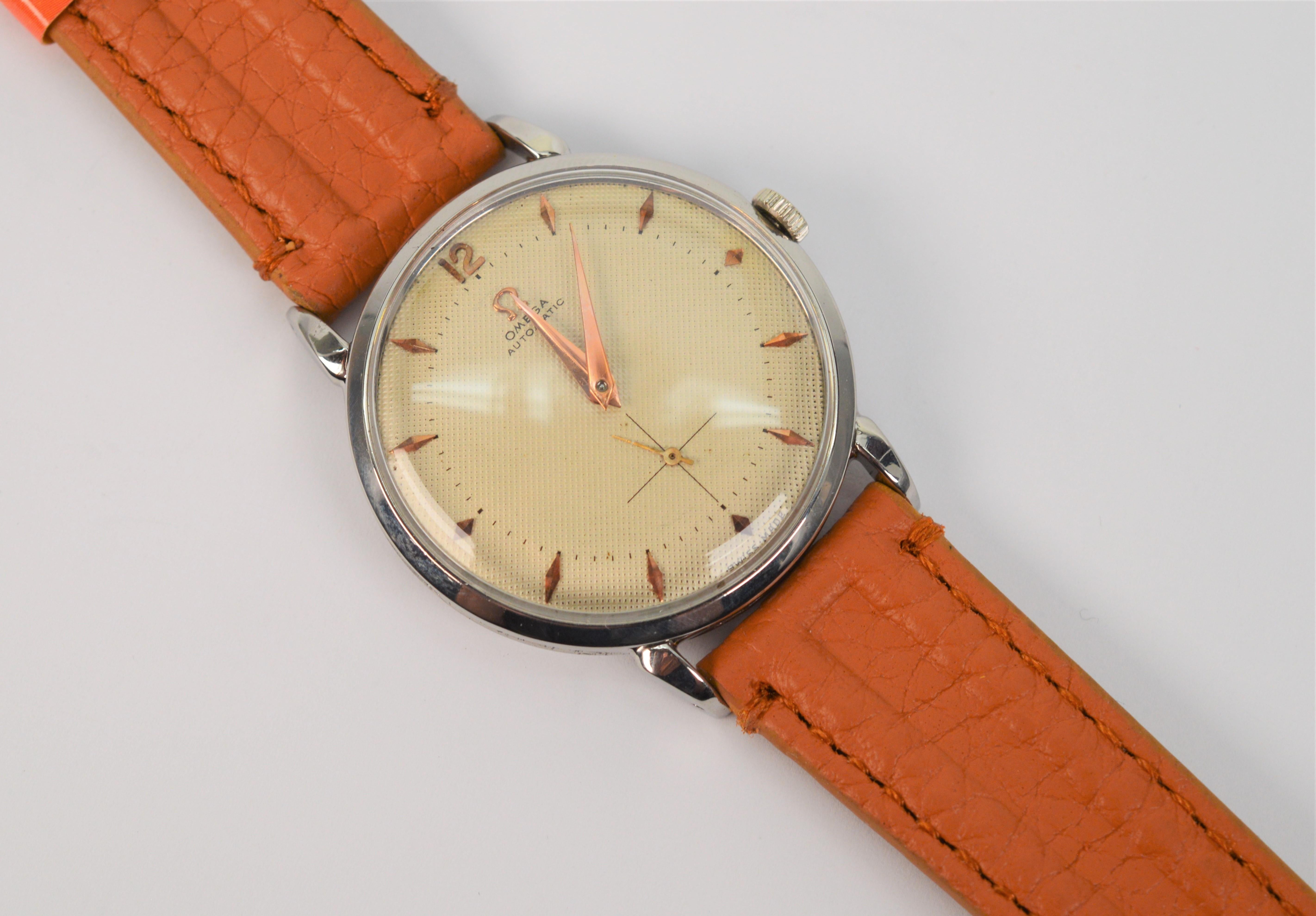 A seventeen jeweled Omega Swiss automatic movement powers this classic Omega 342 Men's Steel Wrist Watch, serial number 13104196. The circa 1952 steel timepiece, case number 2658-2 has a pristine linen color face and coppery color match stick