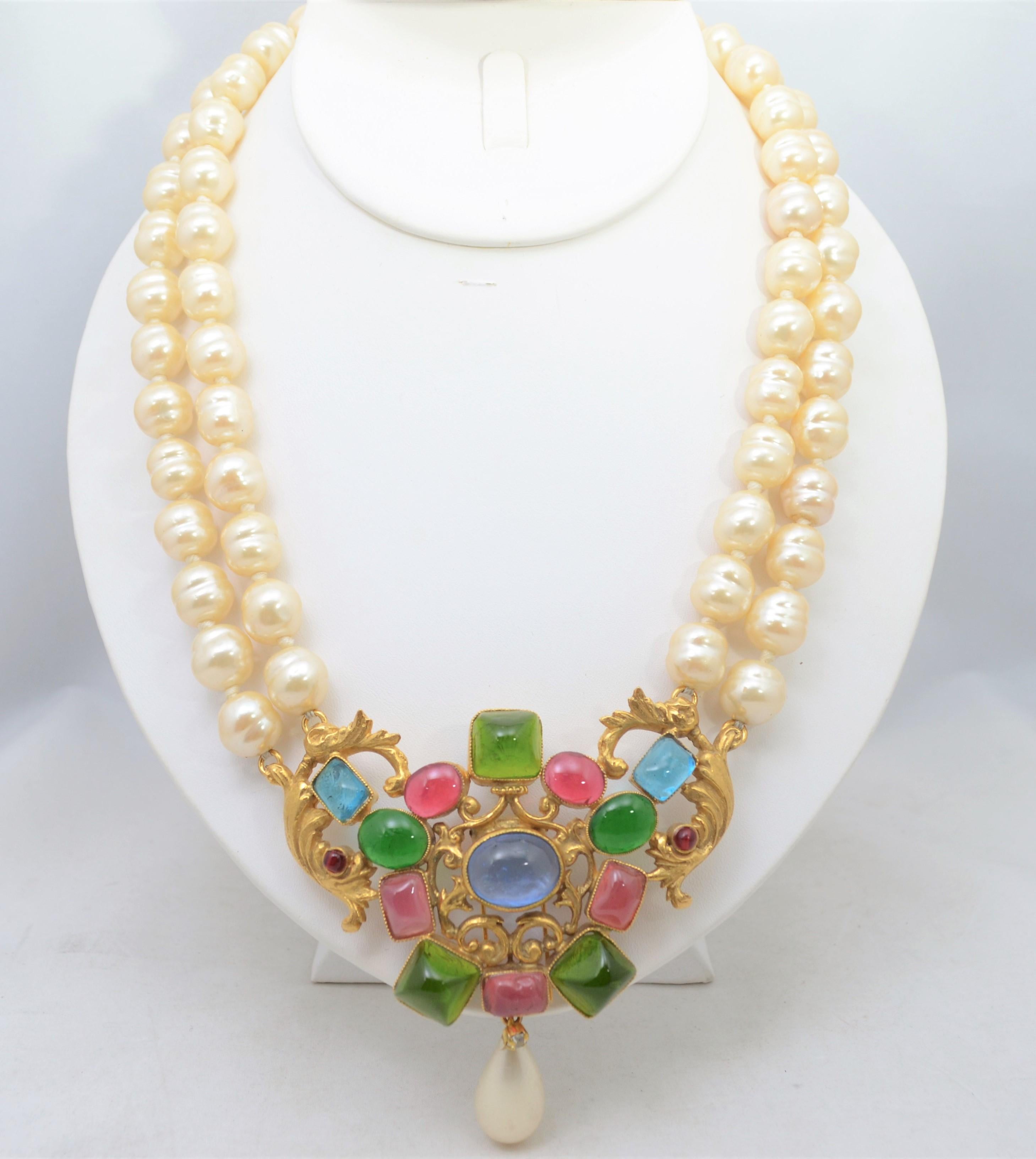 Amazing Chanel baroque pearl double-strand necklace from circa 1950's. Necklace has a gold-tone metal center with glass gripoix stones set in and a hook closure. Gripoix cluster pendant was a fur pin and has been restrung as a necklace. Necklace is