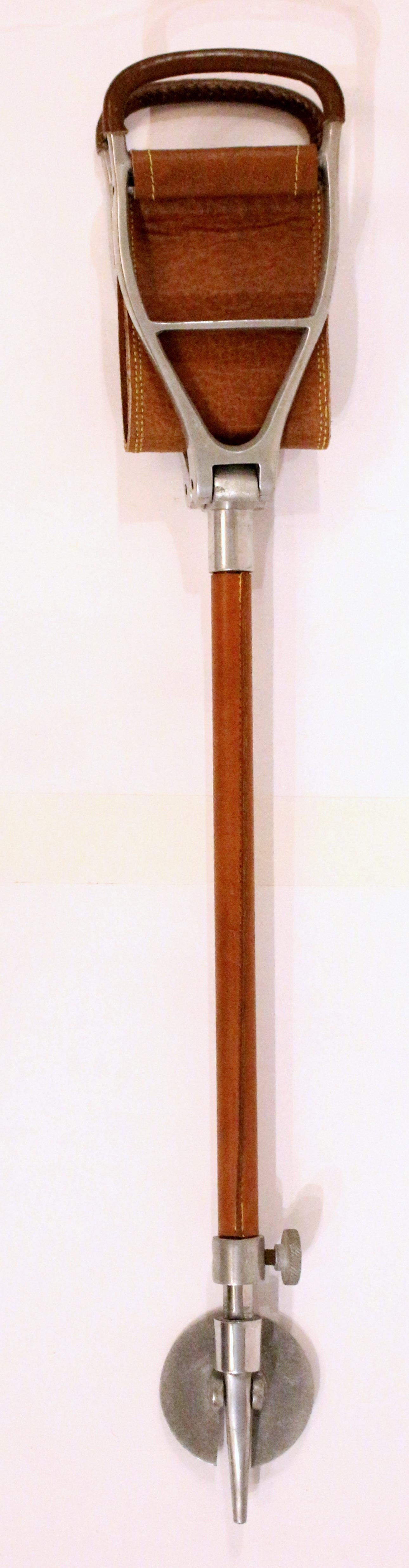Circa 1960 English sporting event or hunting walking stick with folding seat. Steel; the handles & shaft wrapped in leather, leather seat. Adjustable height for comfortable seating. 31