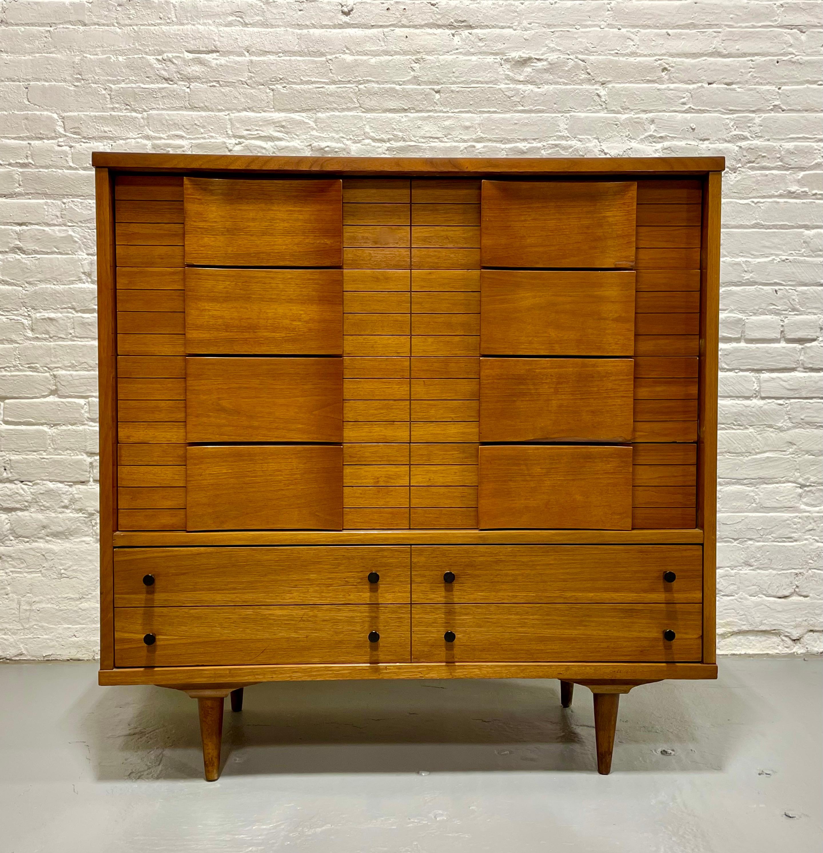 Mid Century Modern Sculpted Dresser by Johnson Carper., c. 1960's.  Beautiful architectural detailing with sculpted drawer pulls. Five spacious dovetailed drawers offer plenty of storage space. Laminated woodgrain tabletop, perfect for sustaining a