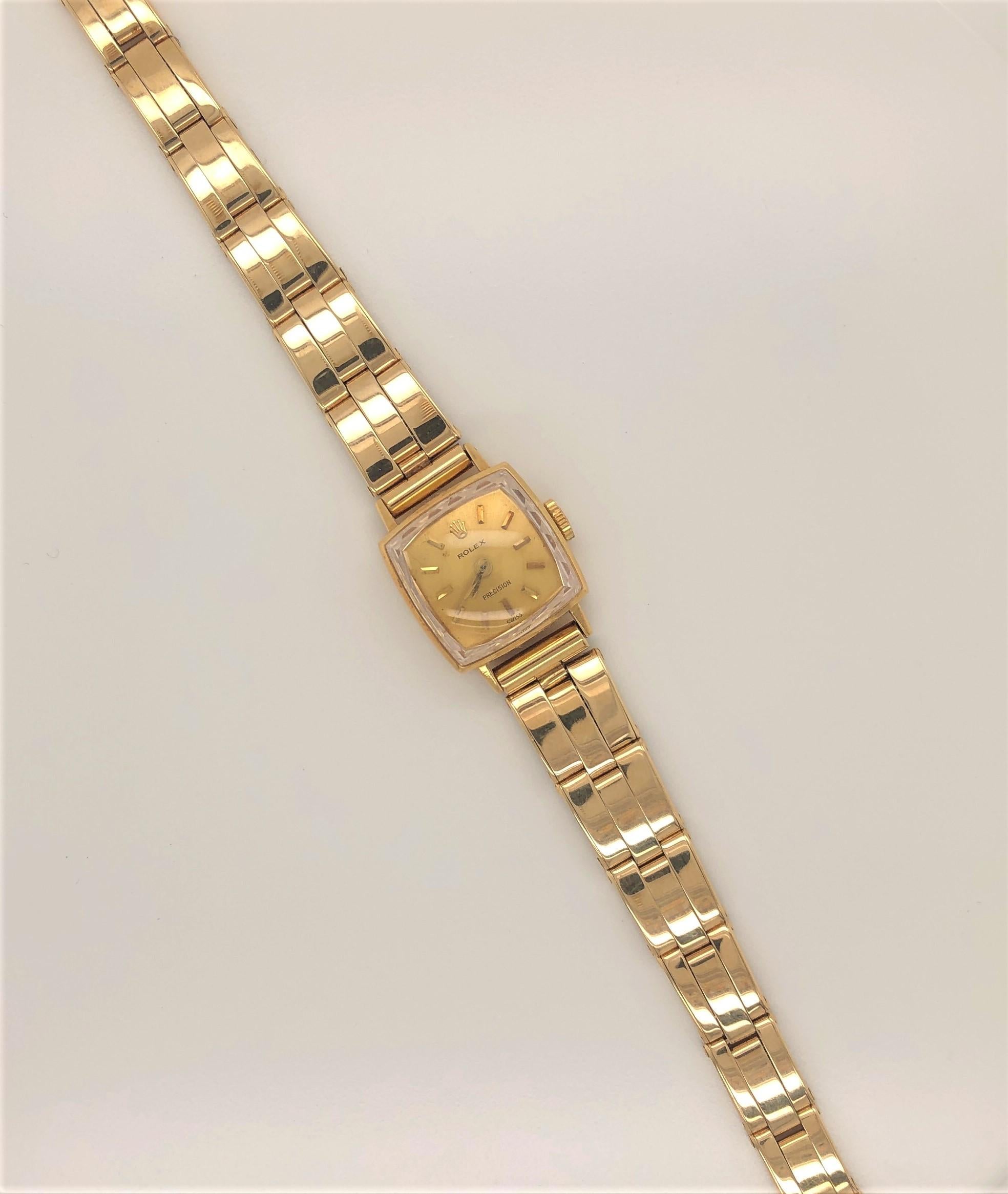 Circa 1960's, Ladies Rolex 1400 Yellow Gold Bracelet Watch. After market seven inch graduated fourteen carat yellow gold link bracelet band with double safety clasp. Square Rolex watch head with eighteen carat gold face, match stick markings and