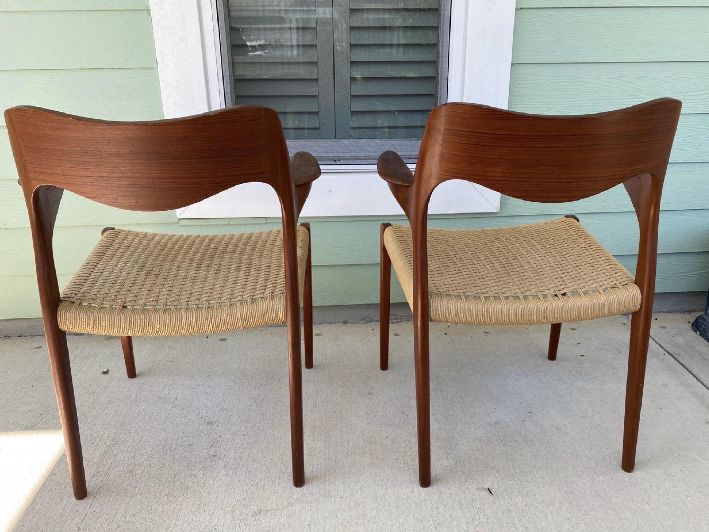 For your consideration we have the iconic set of 2 Niels Møller Captain's Chairs in teak with the Danish Cord Seats. Distinguishing features include beautifully sculpted teak wood and attractive Danish Cord seats. The teak is in great condition and
