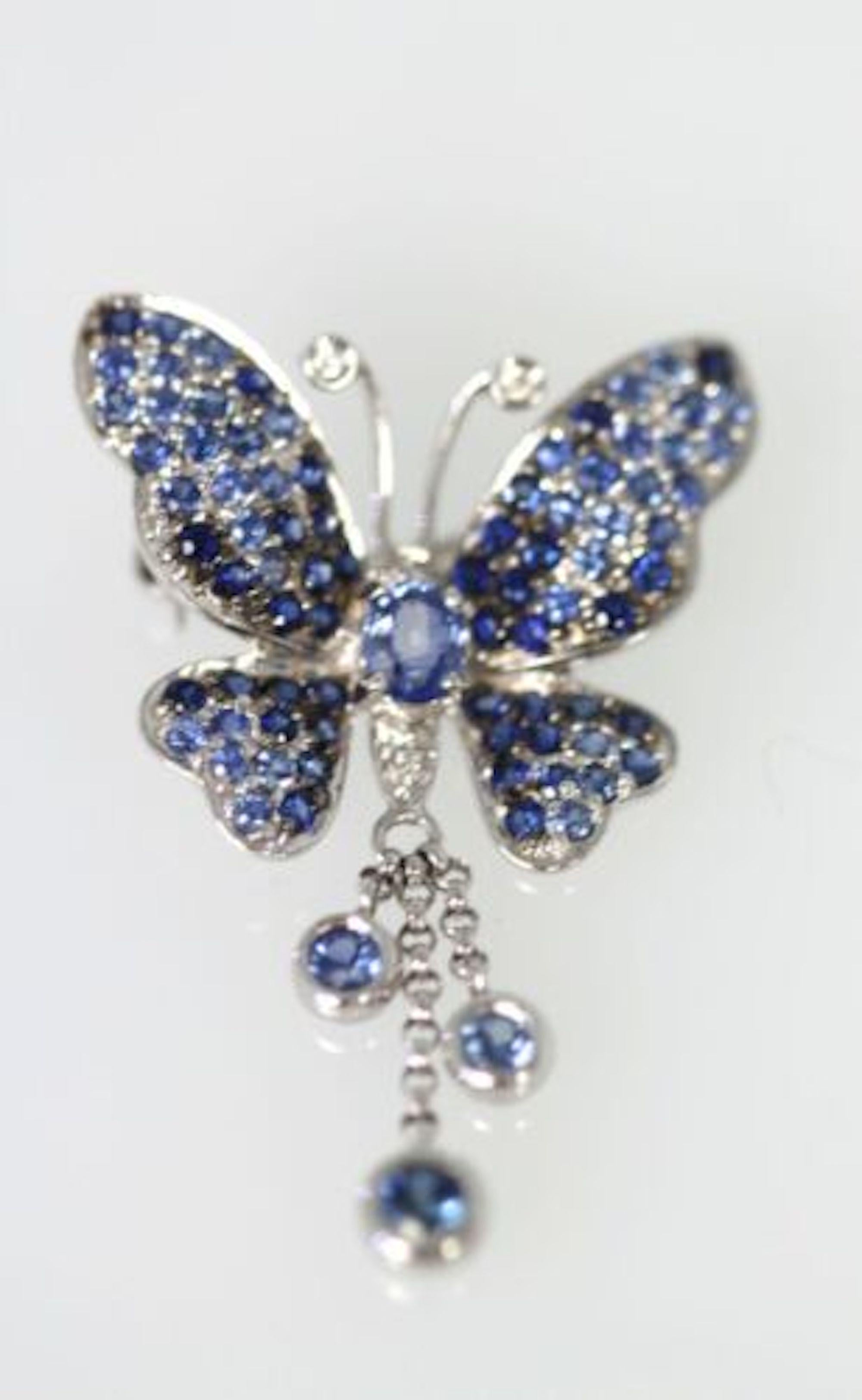 Gorgeous Sapphire, true deep blue Butterfly Brooch or Pendant Circa 1960.  This Pendant/Brooch is set in 18K White Gold.  The butterfly is regal and this gorgeous piece has a tassel of three (3) Sapphires dangling down as a tassel and with movement