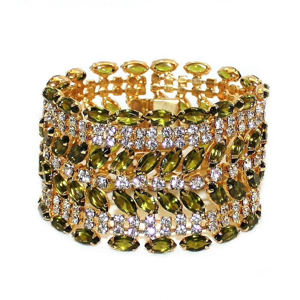 Circa 1960s gold tone metal cocktail bracelet prong set with bright olivine-green faceted marquis stones and embellished with prong set clear rhinestones.  This large, dazzling bracelet measures 7.5