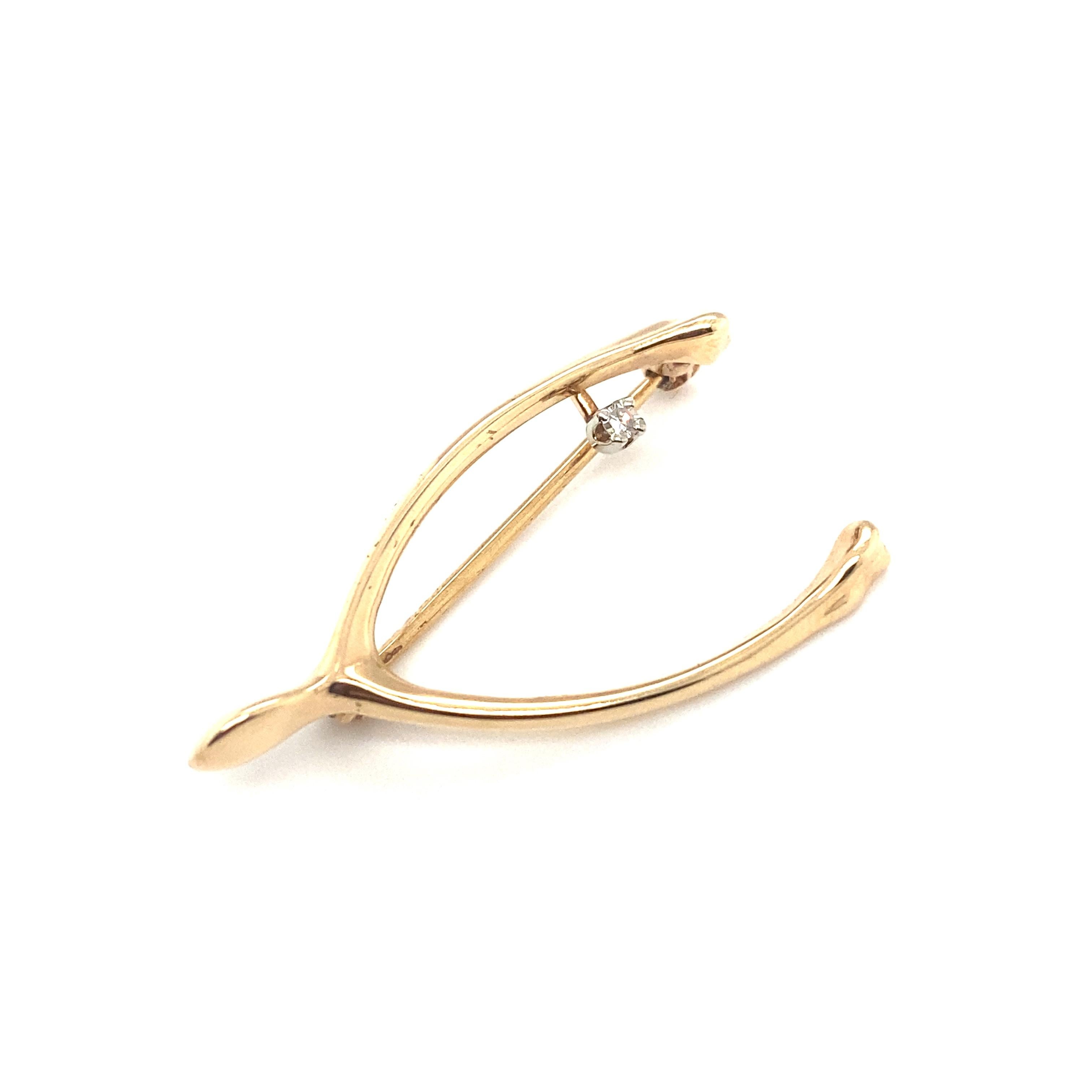Item Details: This wishbone brooch has a single accent diamond. This brooch is in great condition and can be worn with any ensemble.

Circa: 1960s
Metal Type: 14 Karat Yellow Gold
Weight: 2 grams
Size: 1.25