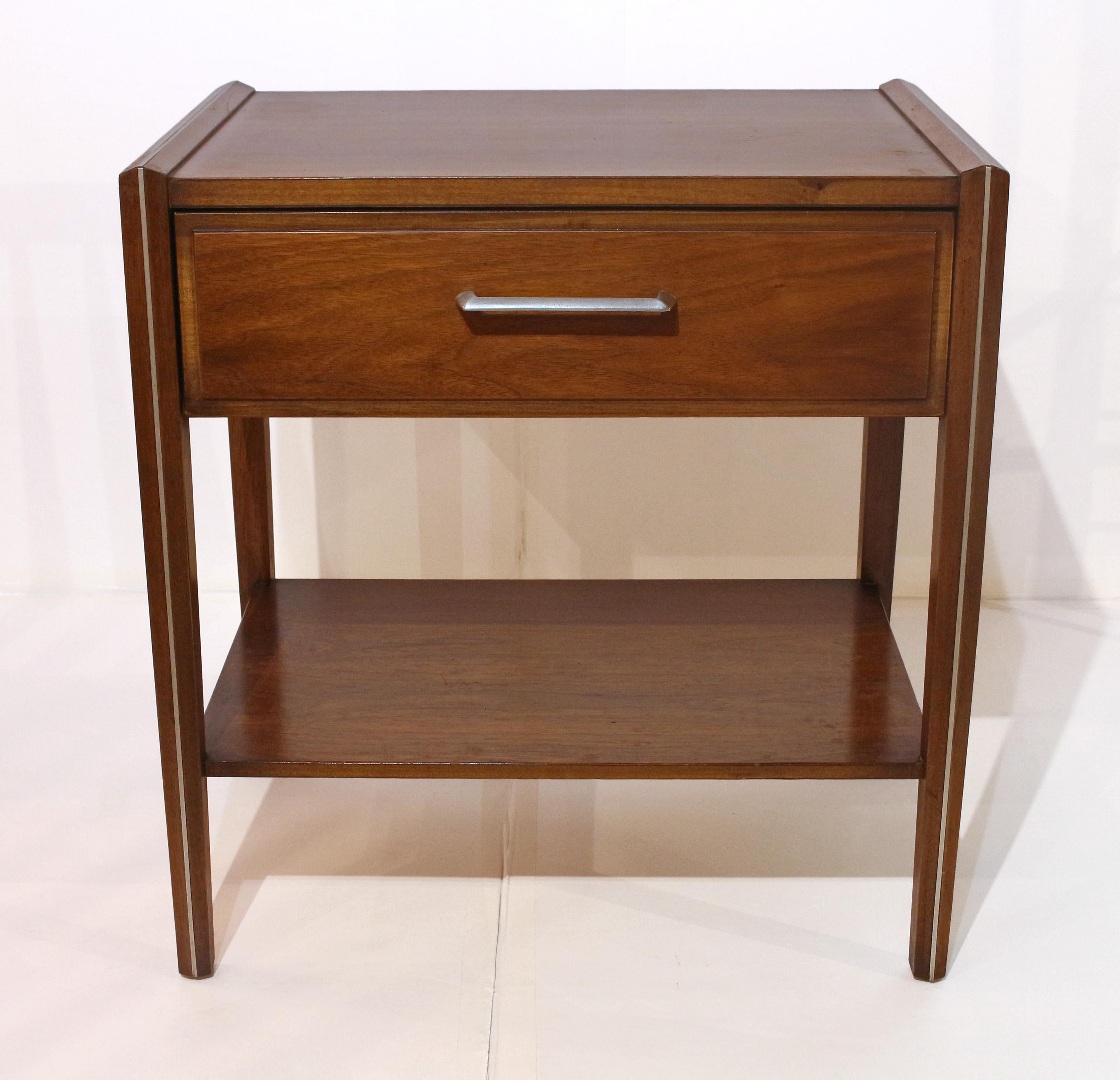 Mid-Century Modern single drawer side table with shelf, American, circa 1960s. Brushed chrome & inlaid walnut and walnut veneered; oak secondary wood. Dovetailed drawer. Chamfered side moldings & legs. All original. Lightly cleaned.
22