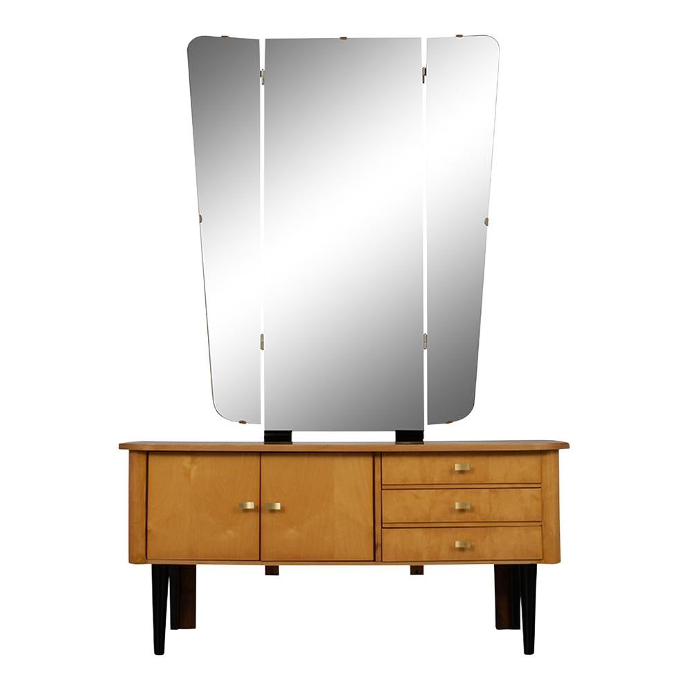This 1960s modern-style German Vanity is made of maple wood that has been stained in a maple & black color combination with a newly lacquered finish. The dressing table has a large foldable mirror, features three pull out drawers with brass pulls,