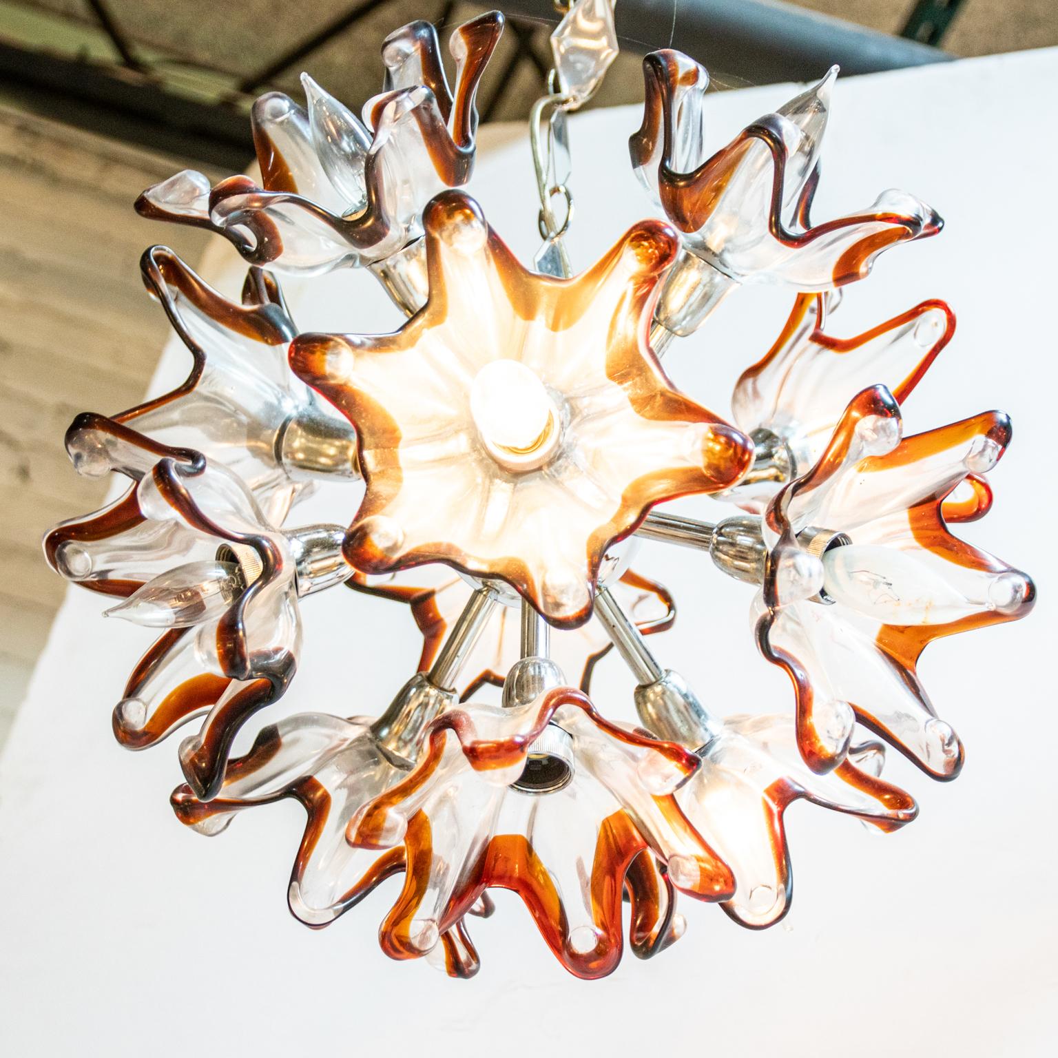Circa 1960s Mid-Century Modern style murano glass and metal chandelier with glass tulip flowers detailed with amber colored glass edges. The chandelier is in a similar form to a Sputnik light fixture of the same Mid-Century Modern style with a