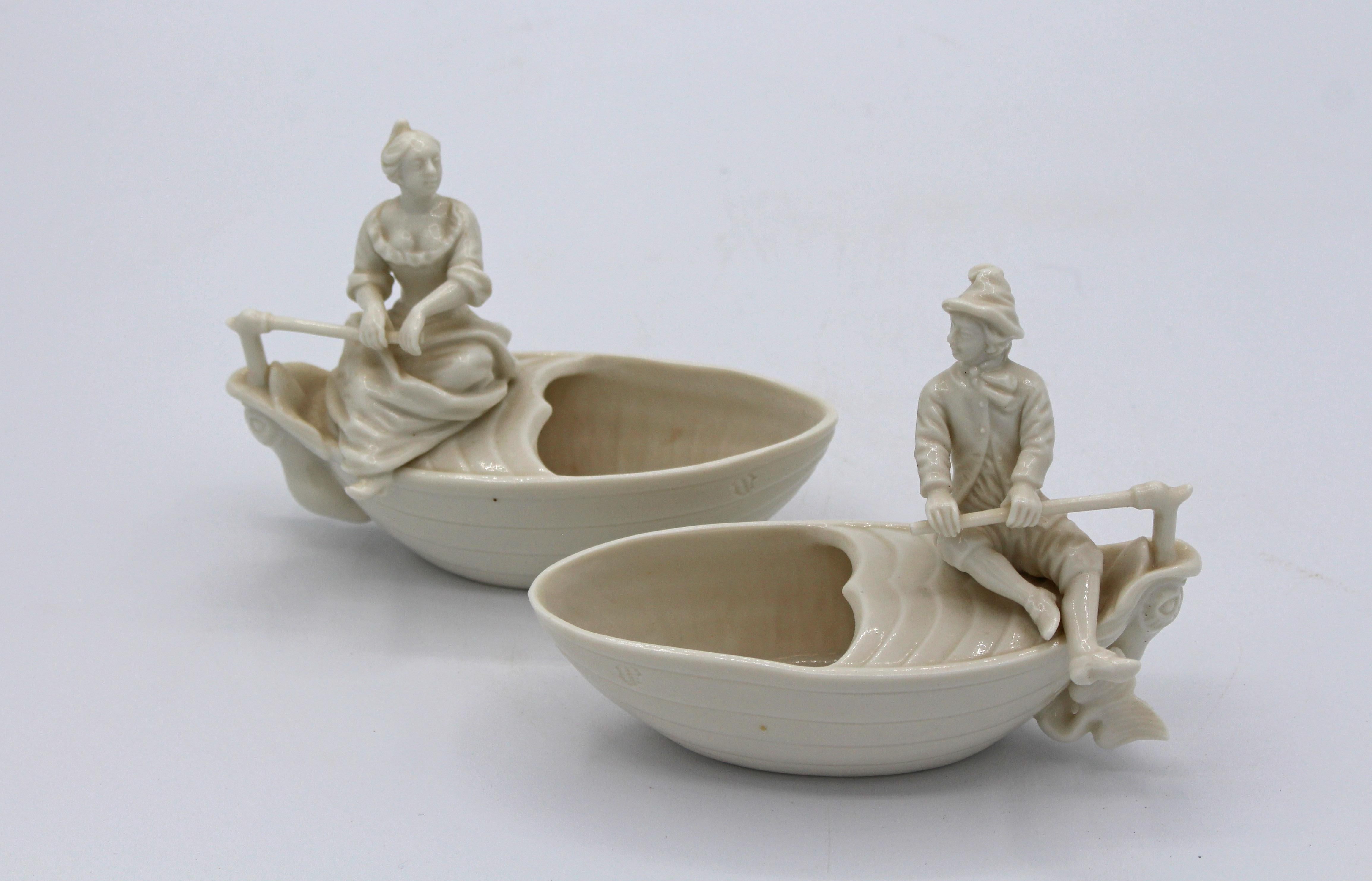 A charming pair of Nymphenburg figural salts (or medicine spoons), each impressed on side of boat and underglaze marks on bottoms. 1960. These very rare pieces are from period Frankenthal molds. Dolphins are the rudders. 4 3/4