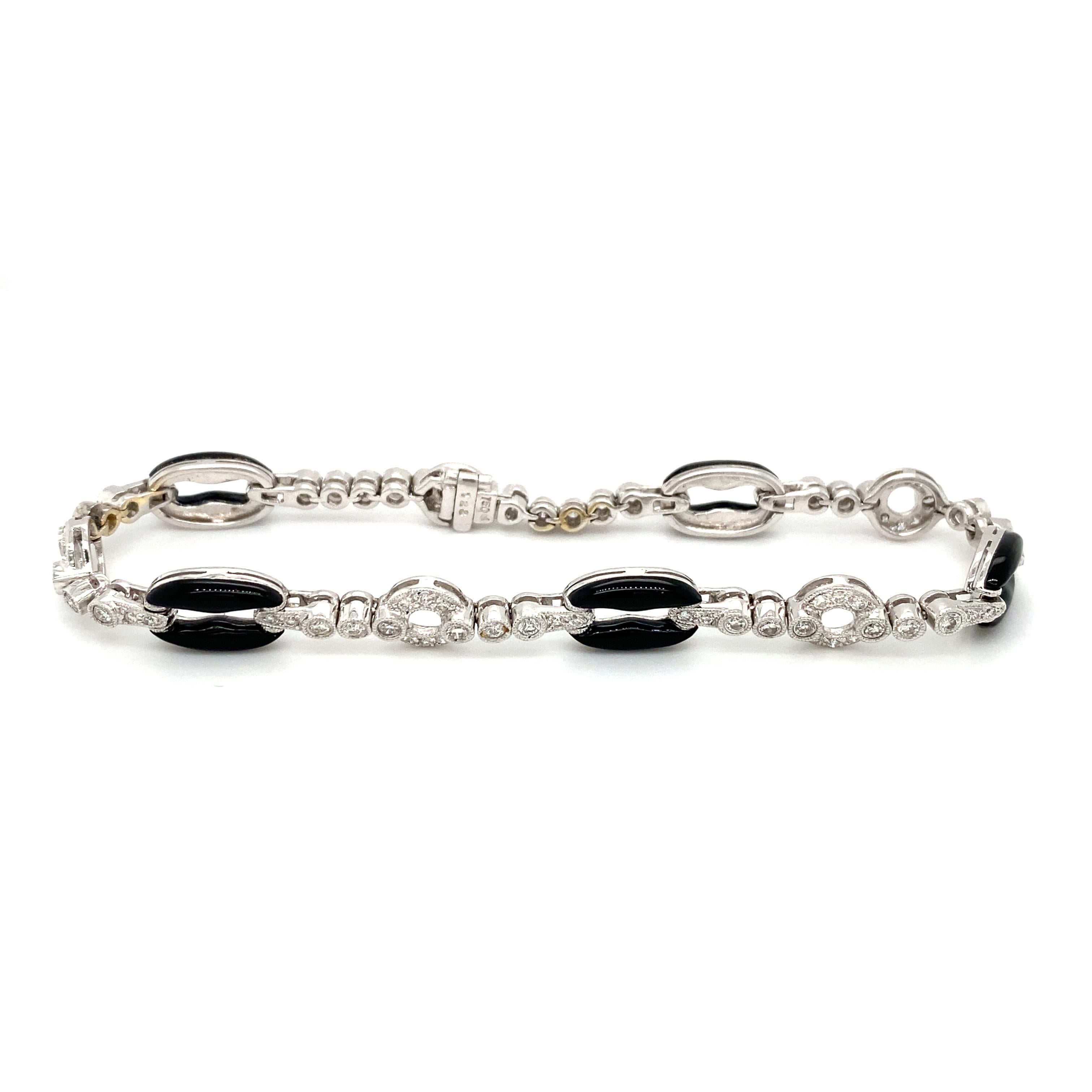 Item Details: This bracelet has onyx and diamonds in a unique linked setting. There are over one carat of diamonds in this tennis bracelet and it is perfect to wear for day or night! Dating back to the 1960s, this is a beautiful retro vintage