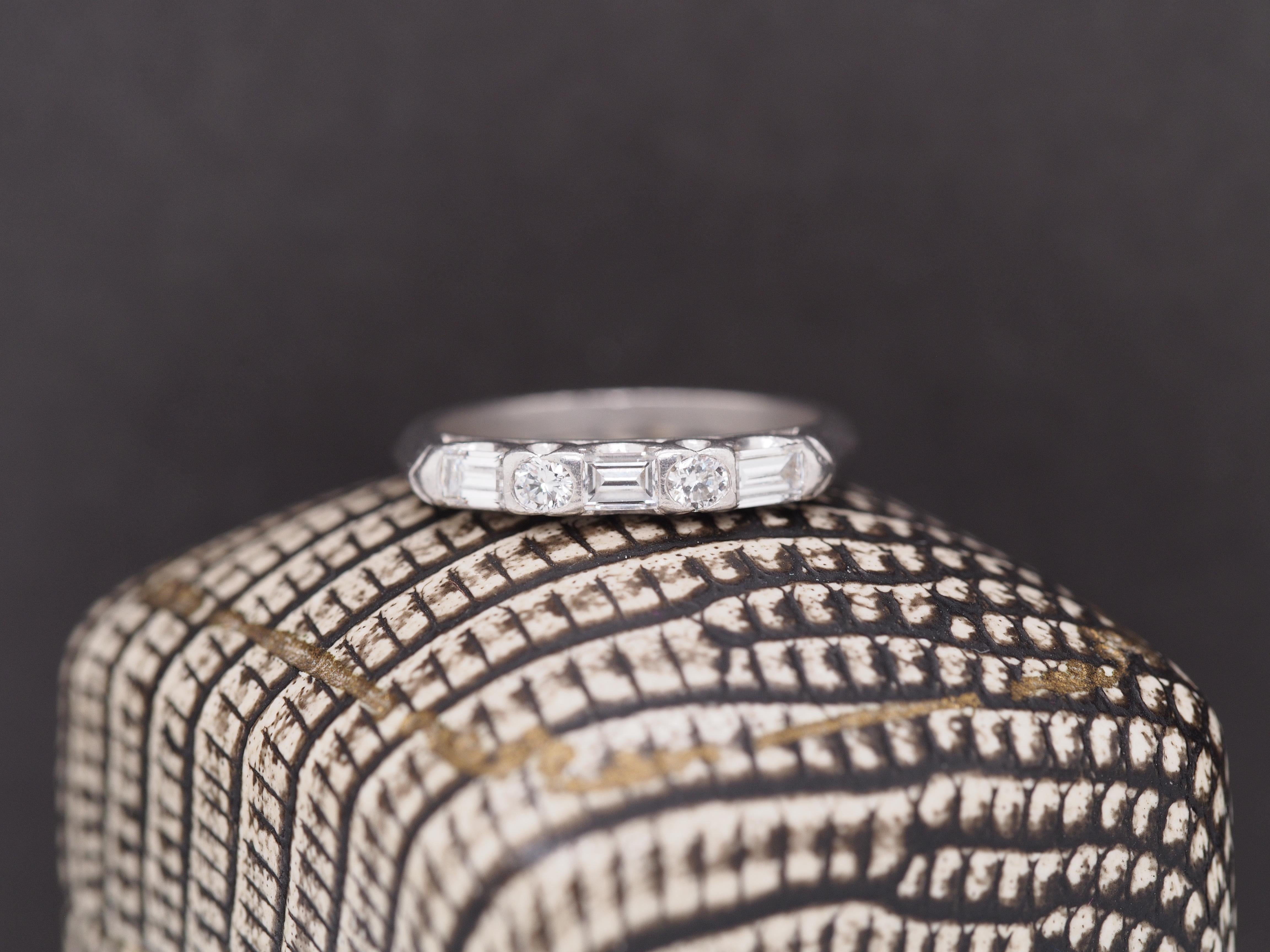 Year: 1960s
Item Details:
Ring Size: 5
Metal Type: Platinum [Hallmarked, and Tested]
Weight: 3.8 grams
Diamond Details: .40ct, total. Transitional Round and Straight Baguette Cut, Natural Diamonds, E/F Color, VS Clarity
Band Width: 2 mm
Condition: