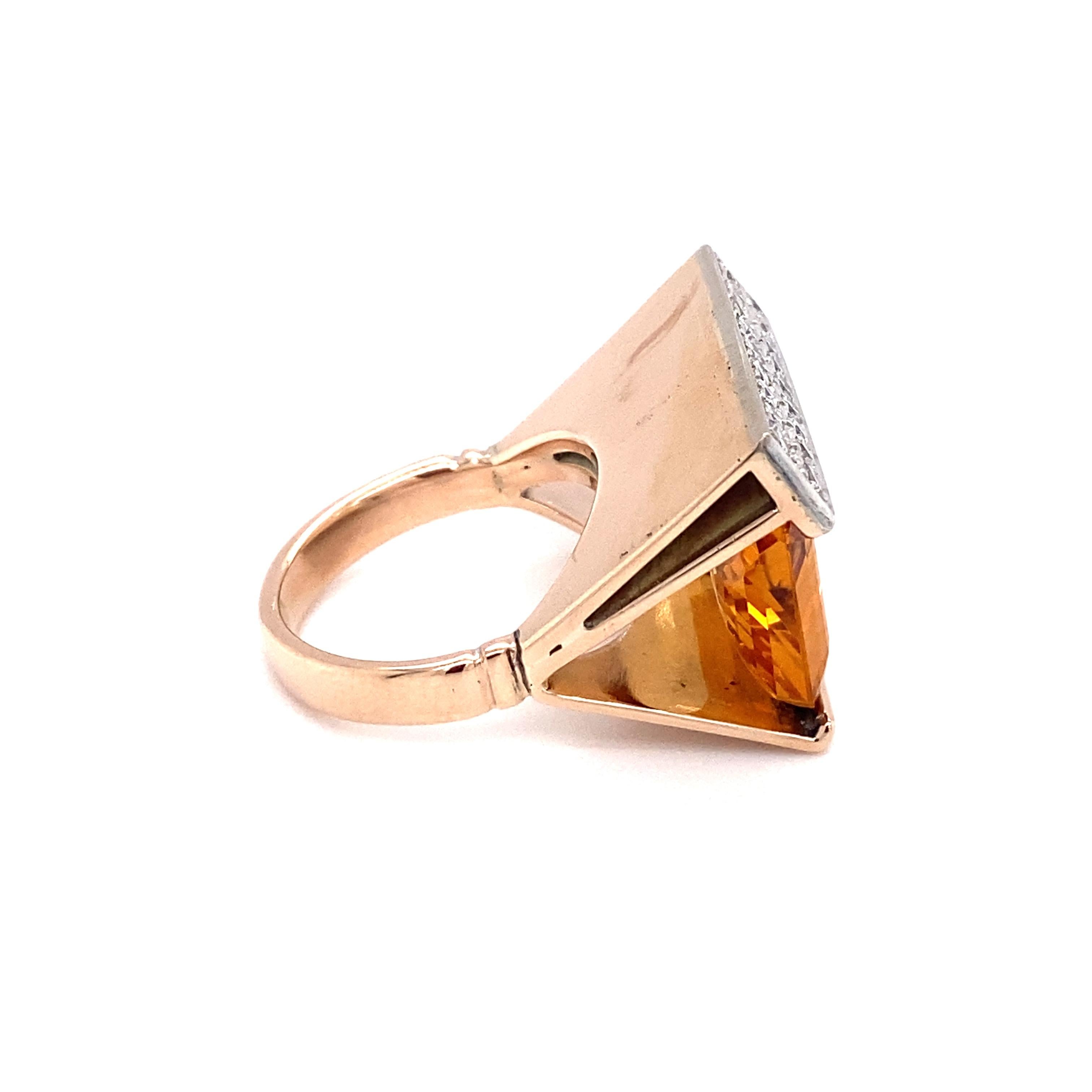 Circa: 1960s
Metal Type: 14 karat yellow gold, with a strong rosy hue
Size: US 6.5
Weight: 14.4g

Diamond Details:

Cut: Round
Carat: 0.50 carat total weight
Color: G
Clarity: VS-SI

Citrine Details:

Cut: Emerald cut
Carat: Approximately 8.7