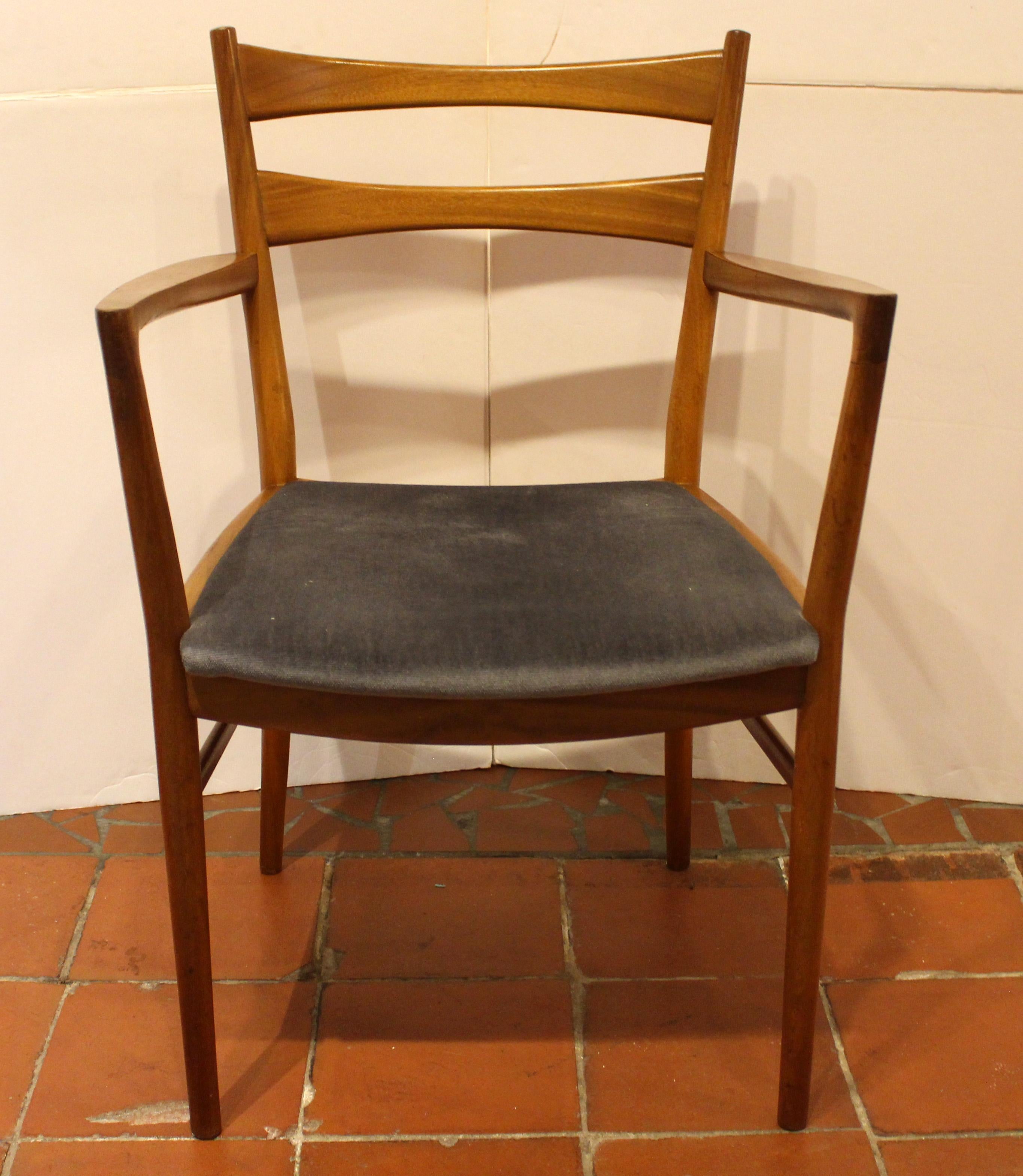 Circa 1960s set of 10 Mid-Century Modern dining chairs by Beithcraft Ltd. of Scotland. Two arms & 8 sides. Shaped double backsplats. Turned tapered legs with turned side rails. Great kick back to the long legs & back supports and sweep to the