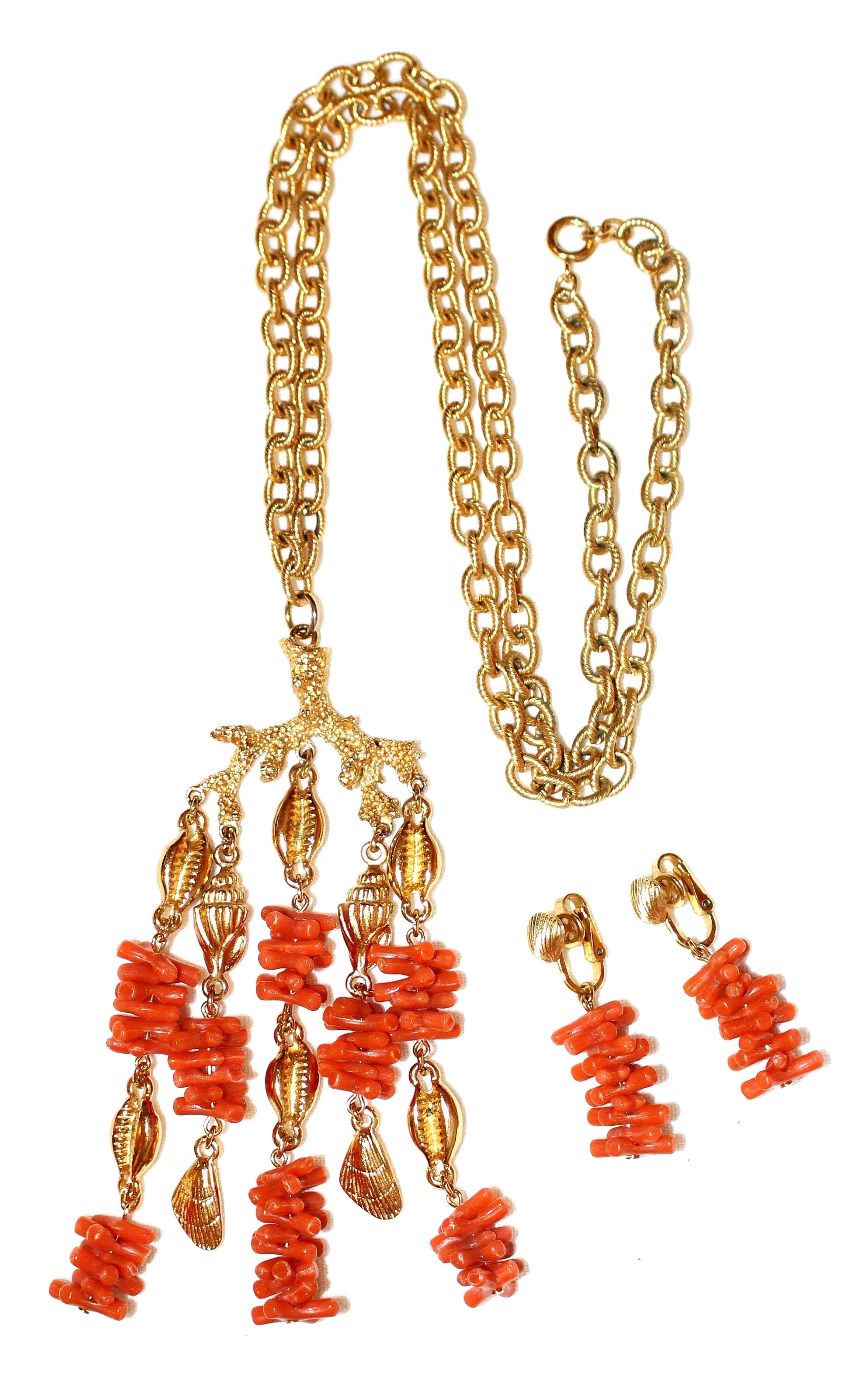  Circa 1950s to 1960s Trifari gold tone metal chain necklace with a large dangling pendant embellished with gold tone shells and faux branch coral. The matching clip back earrings measure 1.75