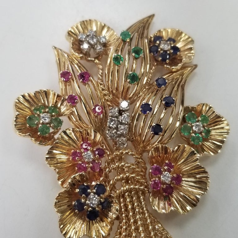 This one of a kind 14kt yellow gold  Circa 1960's with diamonds and gemstones in flower brooch is a must have addition to your jewellery box. The perfect gift for a loved one this stunning brooch has been delicately been hand made to