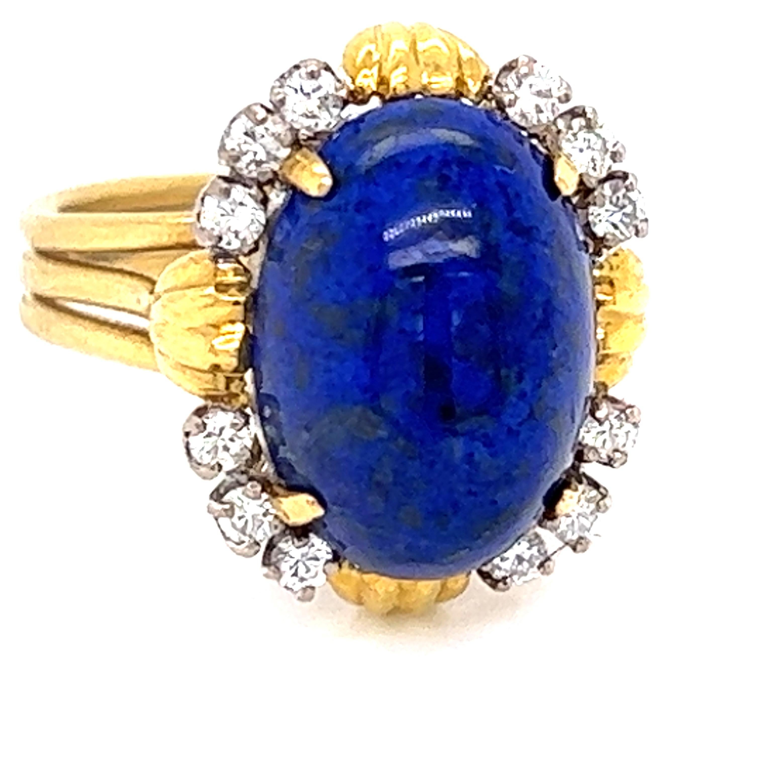 Vintage jewelry collectors delight!  This retro lapis and diamond ring has a large oval lapis, approximately five carats.  It is highlighted by twelve round brilliant diamonds totaling approximately .50 ctw.  SI in clarity, IJ in color.  This ring