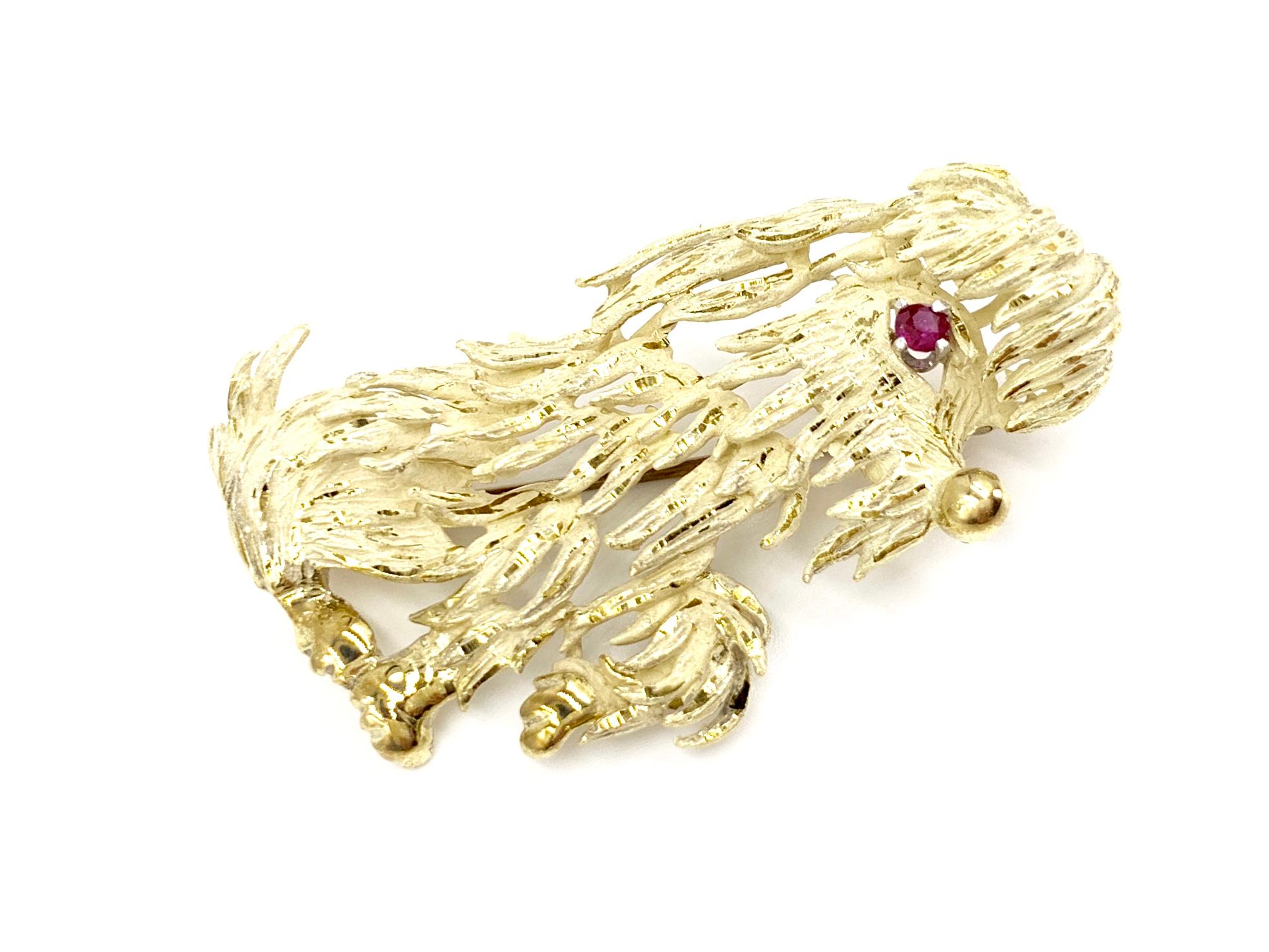 Unique vintage hand made 14 karat yellow gold shaggy dog brooch featuring one round ruby eye. Brooch has a matte, acid wash finish with shiny, hand polished texture to add dimension and design. Back pin closure works perfectly.
Length of brooch