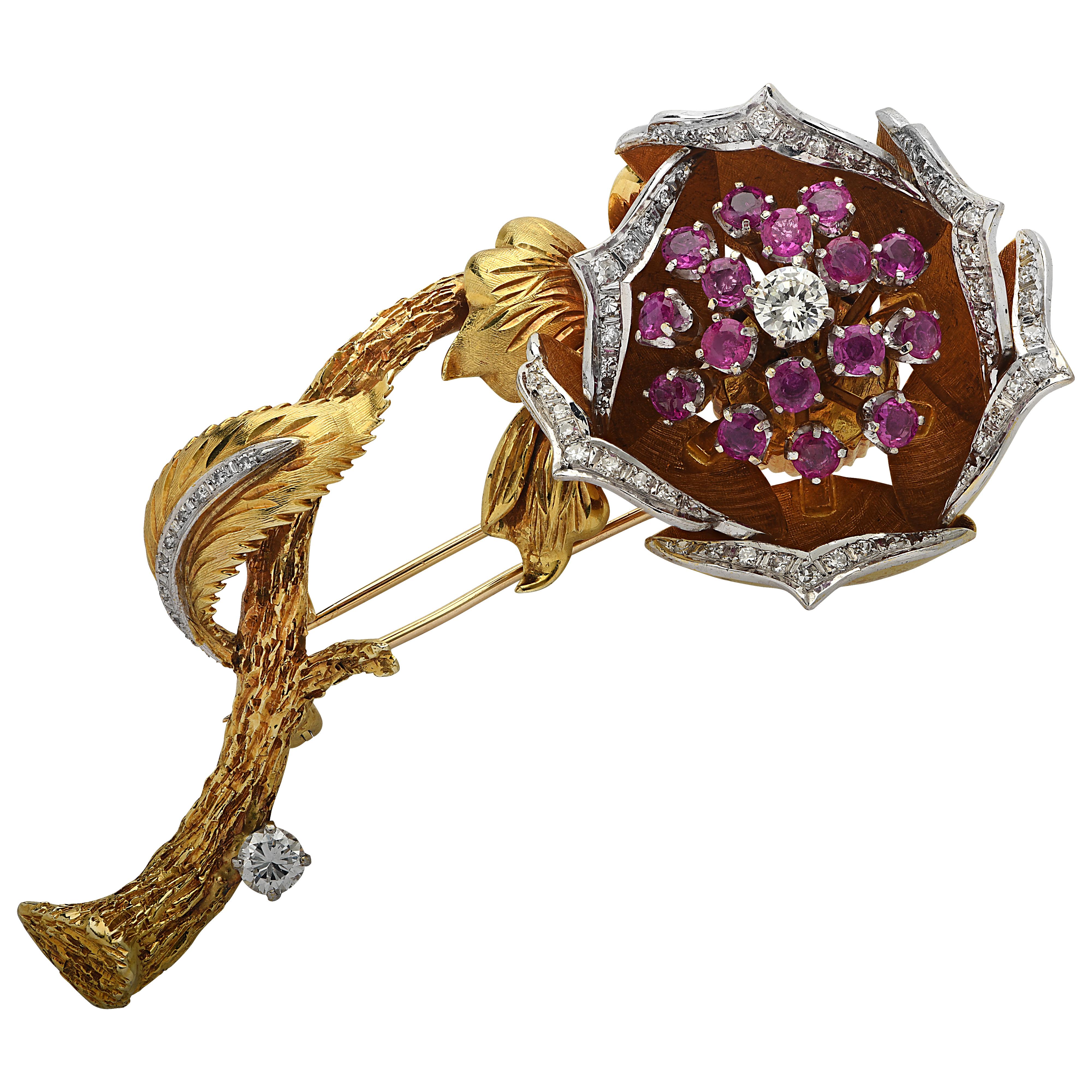 Enchanting brooch pin circa 1970s crafted in 18 karat yellow and white gold featuring 66 round brilliant cut diamonds weighing approximately 1 carat total, G color, VS-SI clarity, and 16 round rubies weighing approximately 2 carats total. The brooch