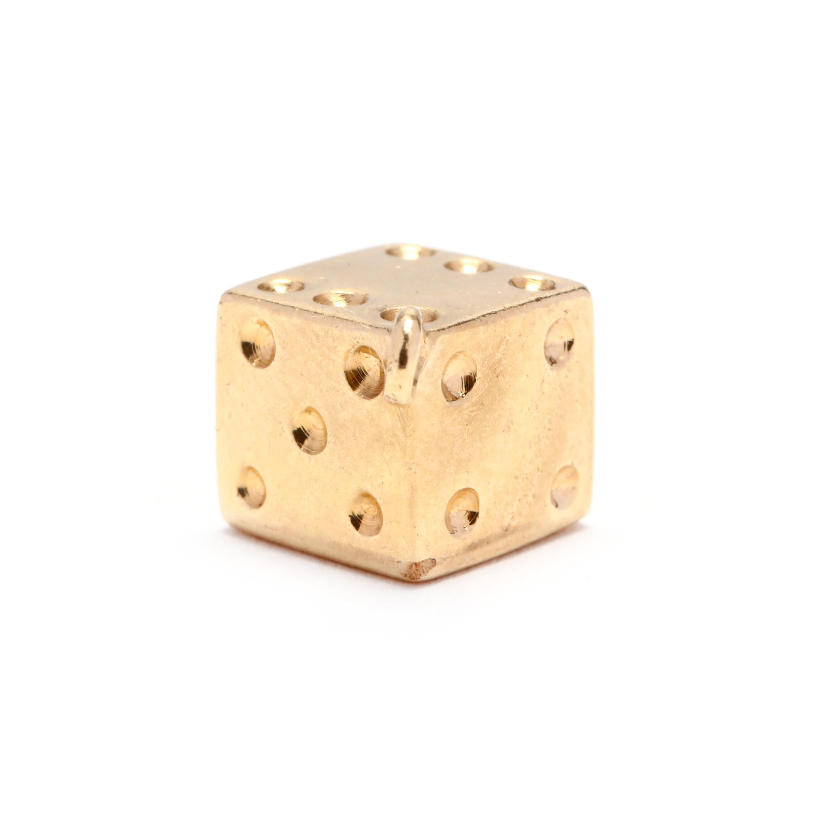 Circa 1970's, a vintage 14 karat yellow gold dice charm. A cube design in a dice motif.

Length: 9/16 in.

1.97 dwts

* Please note that this is a vintage item and may show signs of wear. It has been cleaned.

* Please feel free to message us with