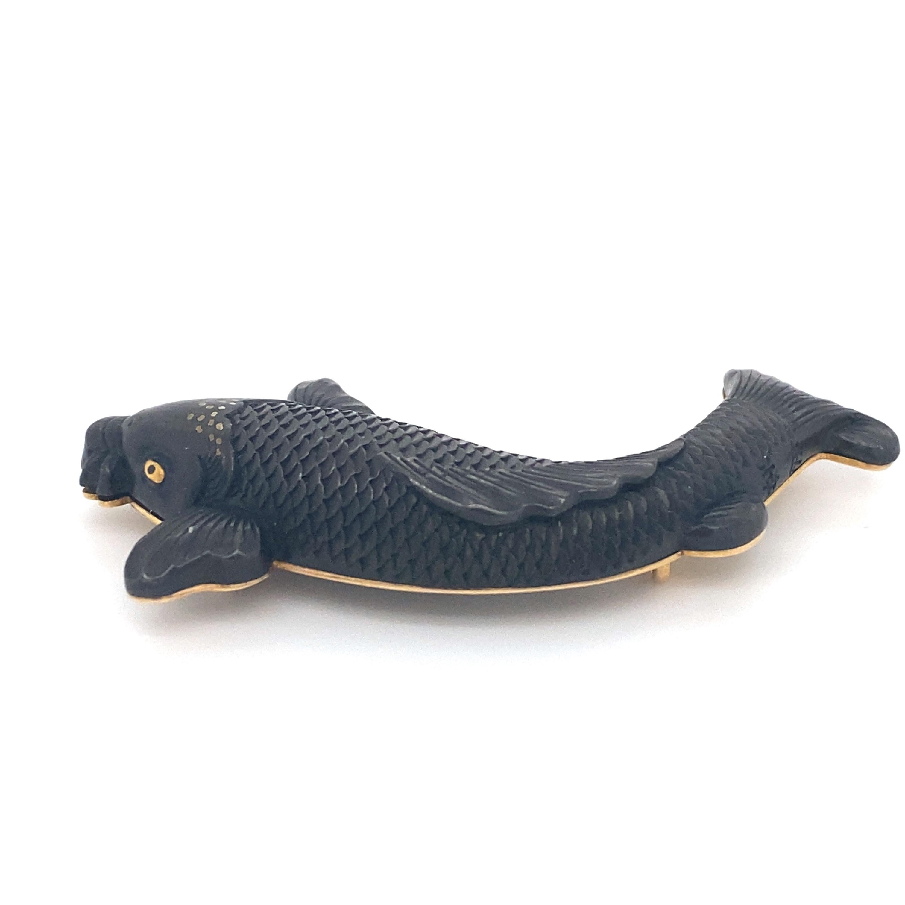 Item Details: This unique onyx koi fish pendant has 18k gold accents.

Circa: 1970s
Metal Type: 18 karat gold
Weight:  12.7 grams
Dimensions: 2 inch Width