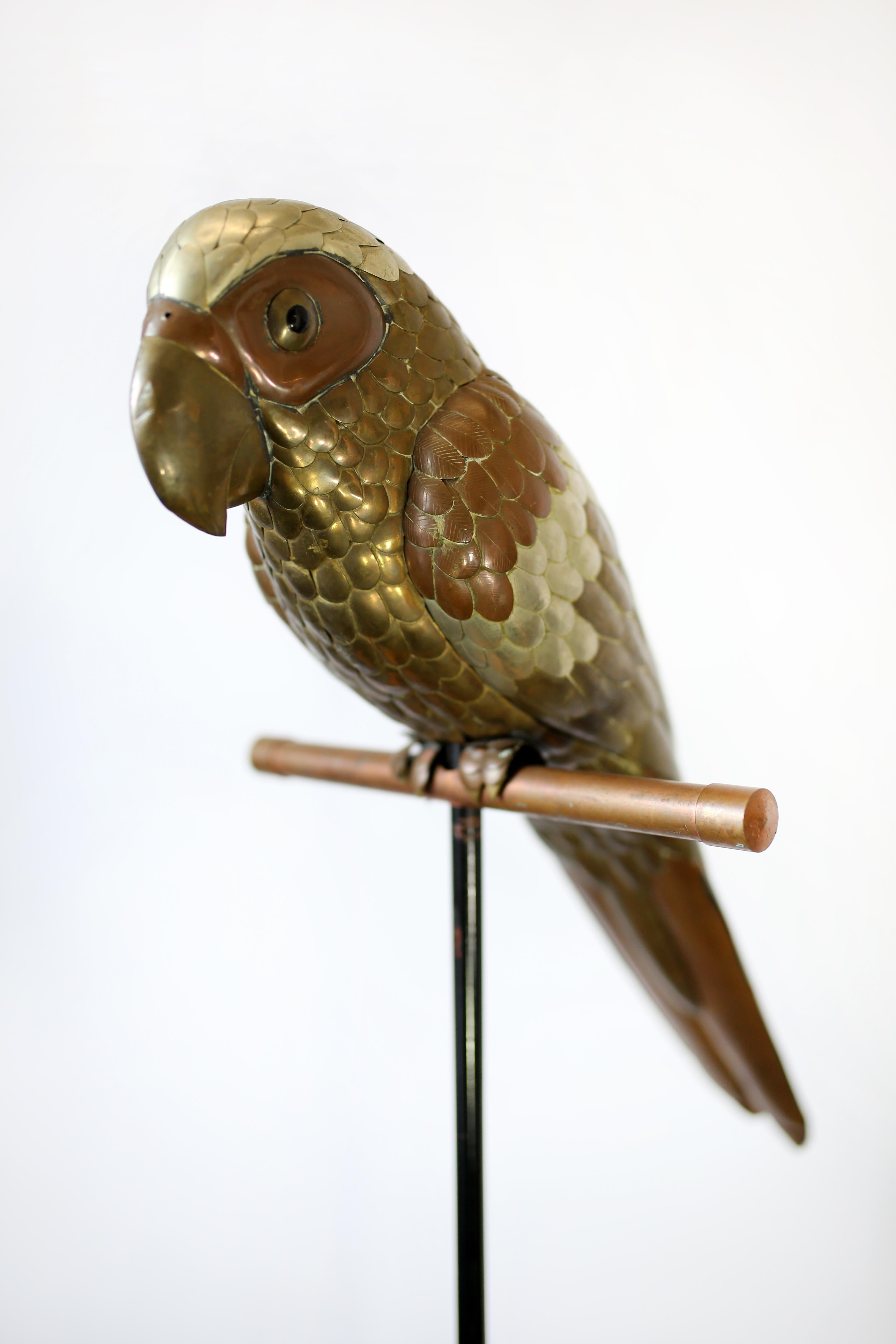 This large brass and copper parrot sculpture by Sergio Bustamante is in overall good condition and wear consistent with age and use. Perch stand included. Everything about Bustamante's animals scream whimsy and gentle fun, and this handcrafted,