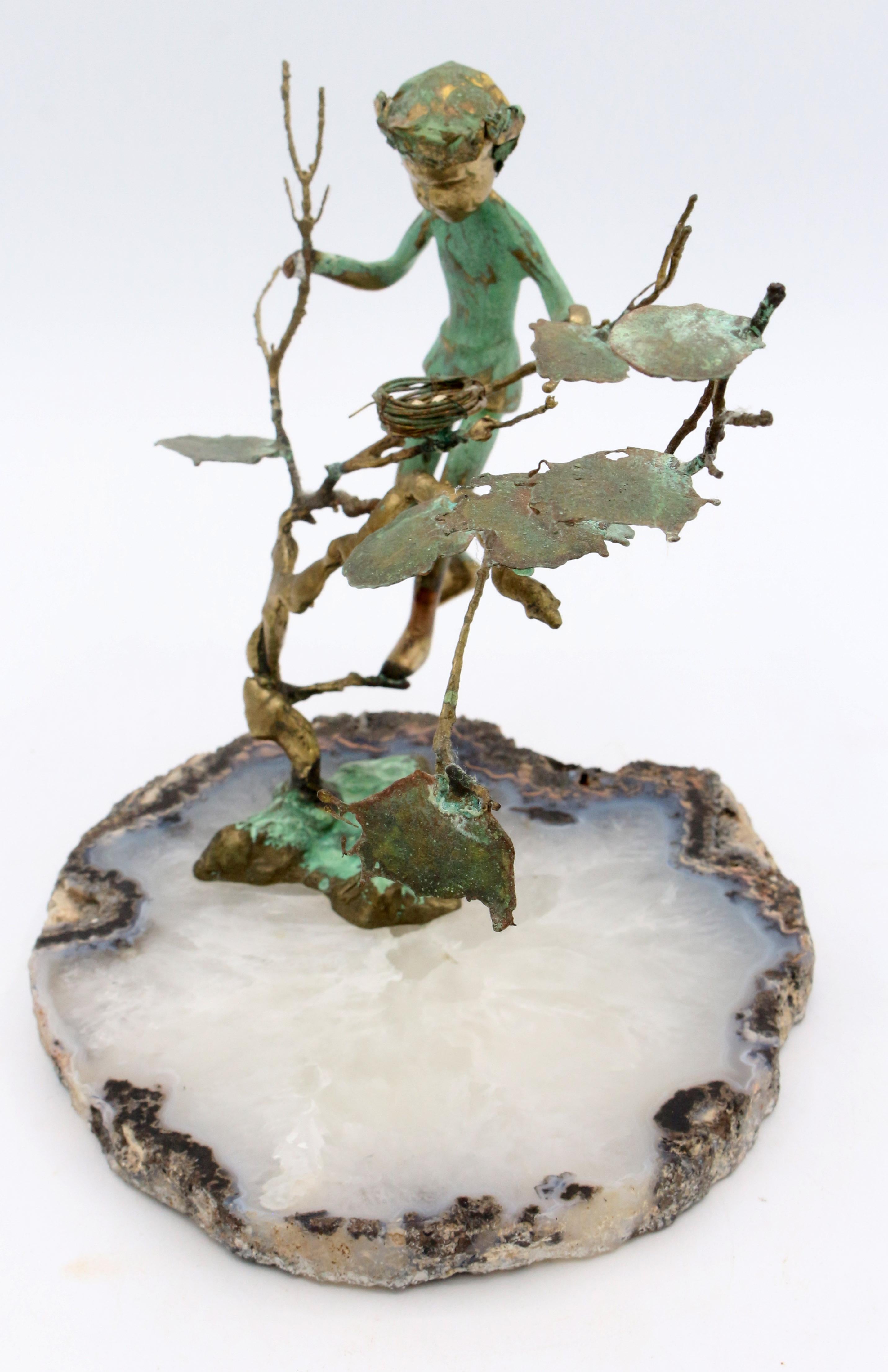 Circa 1970s bronze sculpture by Malcolm Moran, Carmel, CA. Verdigris patinated bronze on natural geode base. Copyright stamp. A boy climbing a tree, looking at a bird's nest with 3 eggs.
6.5