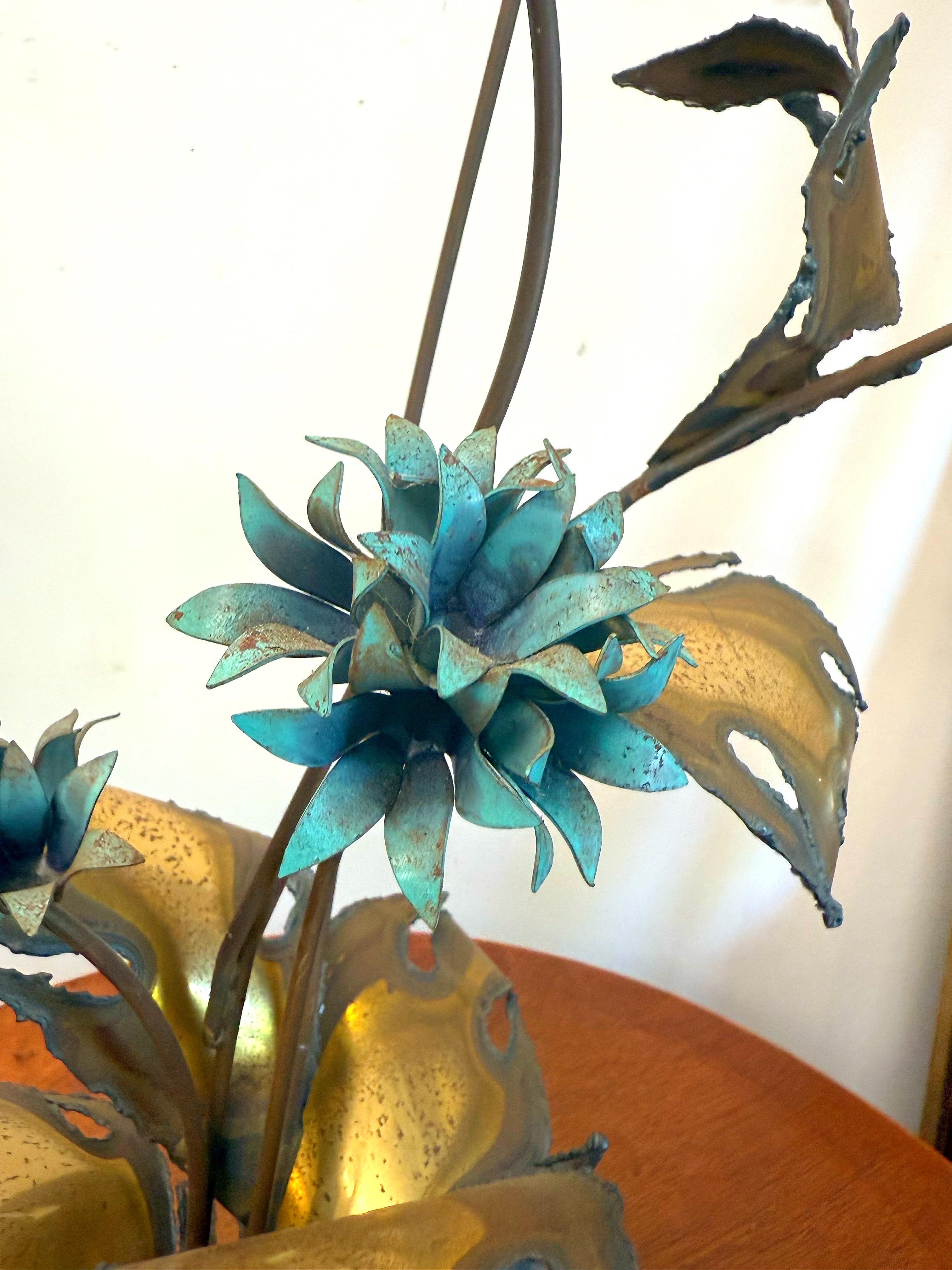 This excellent brutalist sculpture has 4 verdigris color flowers and torch cut bronze leaves that all sit on a solid piece of quartz.  Circa 1970’s.  Styled after John Steck, not signed.