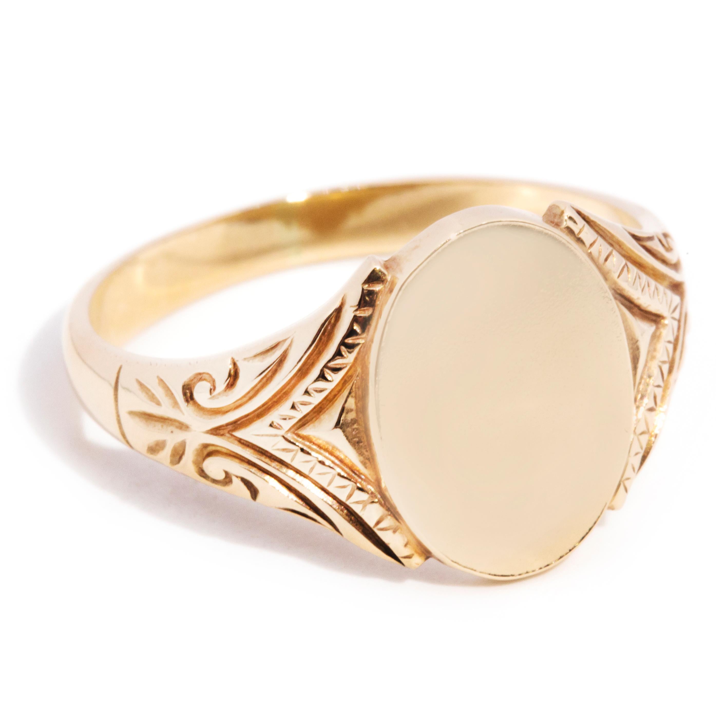 Forged in 9 carat yellow gold, this dapper men's signet ring features a high polish curved band flowing into intricate pattern shoulders and an unmarked oval platform with room for personal engraving. We have named this suave vintage jewel The